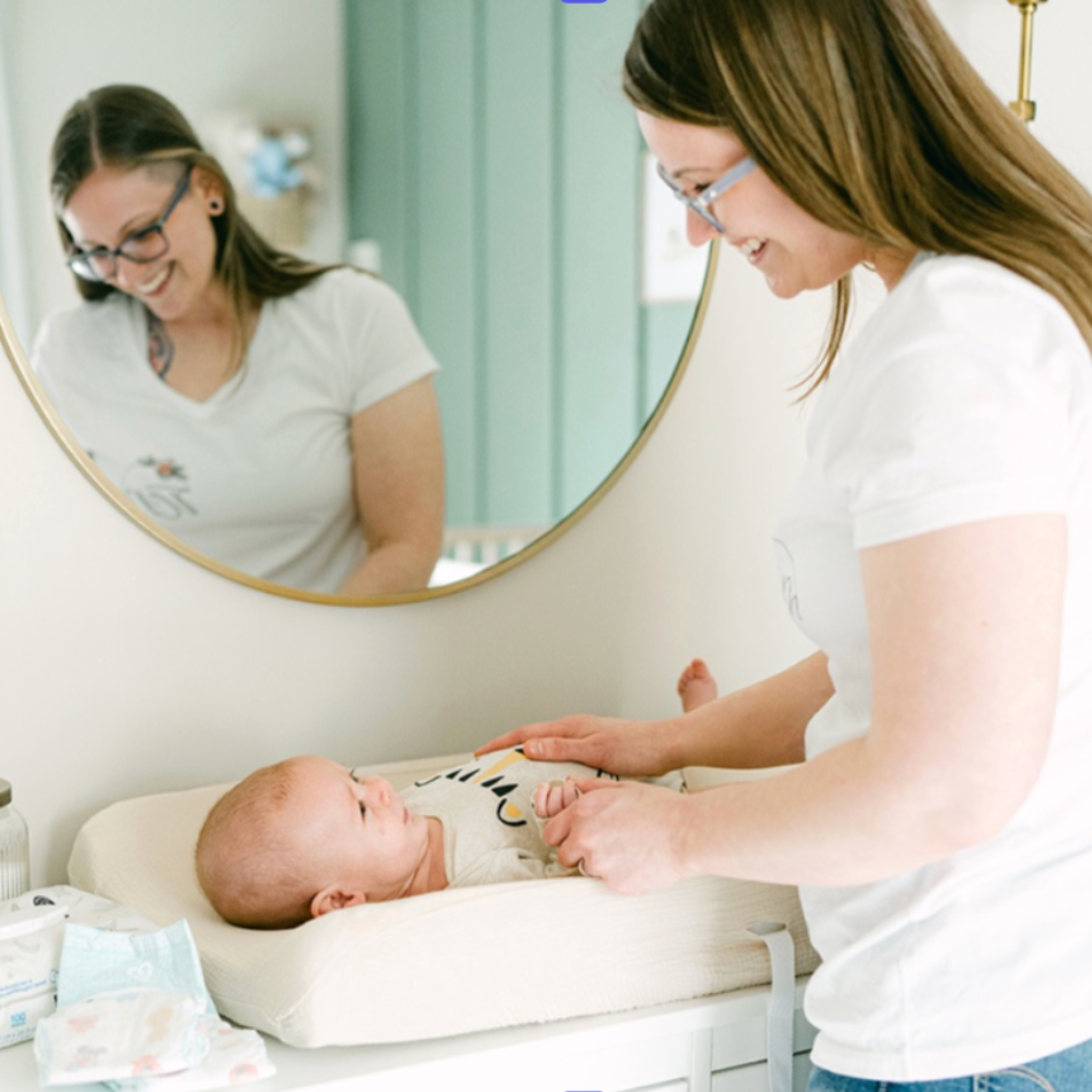 postpartum doula changing babies diaper