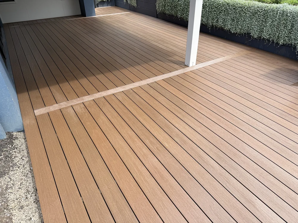 Composite deck Brisbane — warm tones under pergola