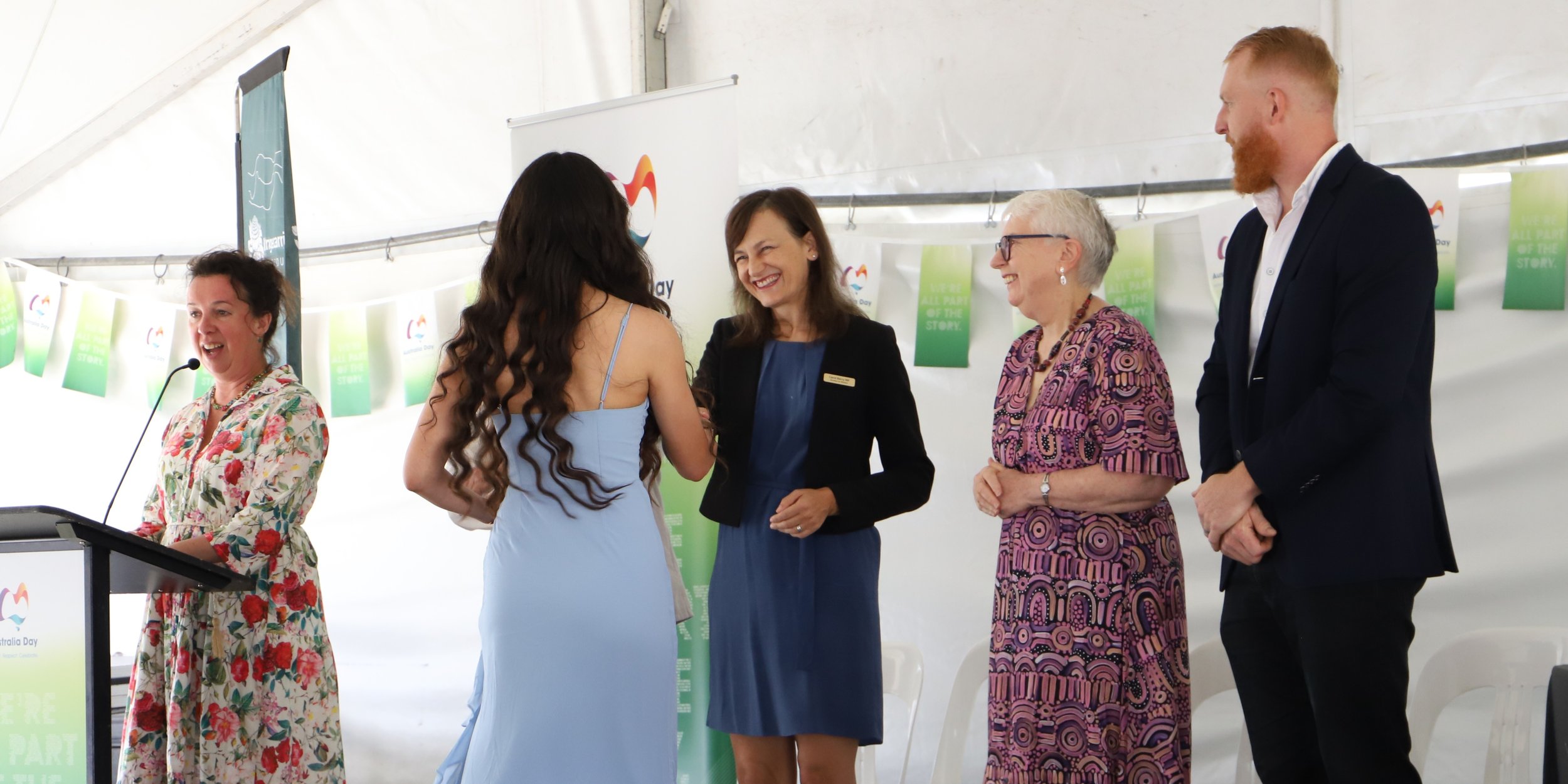 A woman receiving an award or recognition from Carol Berry MP at Australian Day in Berrima, while three other individuals look on.