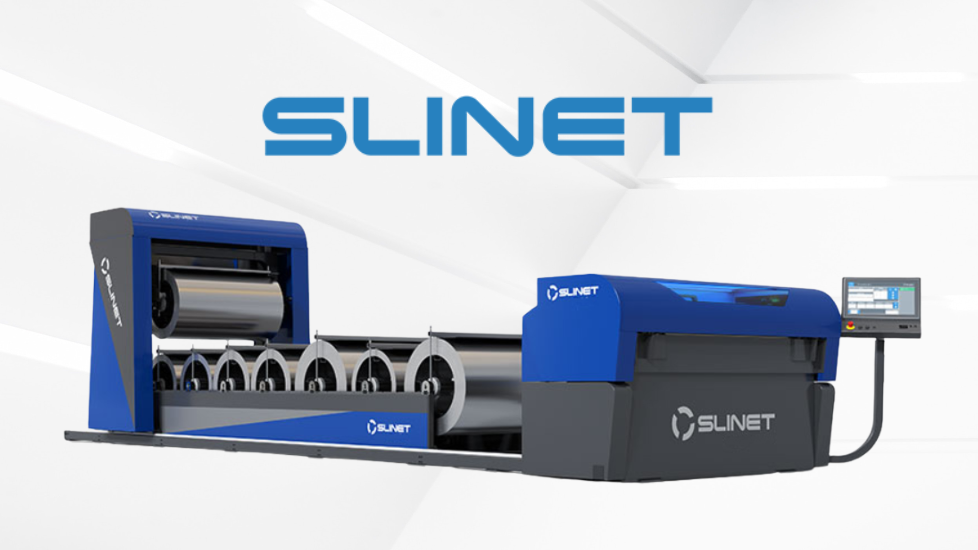 A large industrial machine in blue and gray labeled SLINET, with rollers and a computer control panel on the right side, used for manufacturing or printing processes.