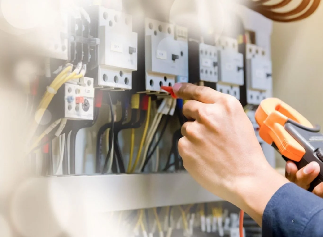 Person testing electrical circuit breaker with a multimeter.