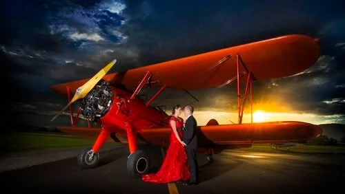 Wedding couple photographed with a vintage aircraft