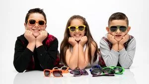 Children modelling colourful sunglasses