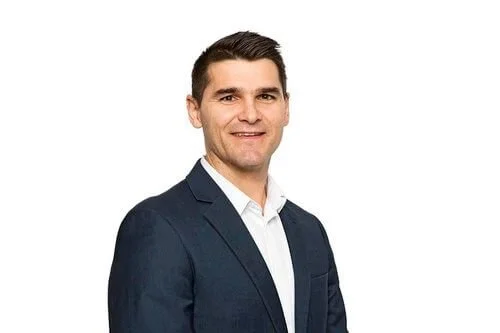 Professional headshot of a man in a suit