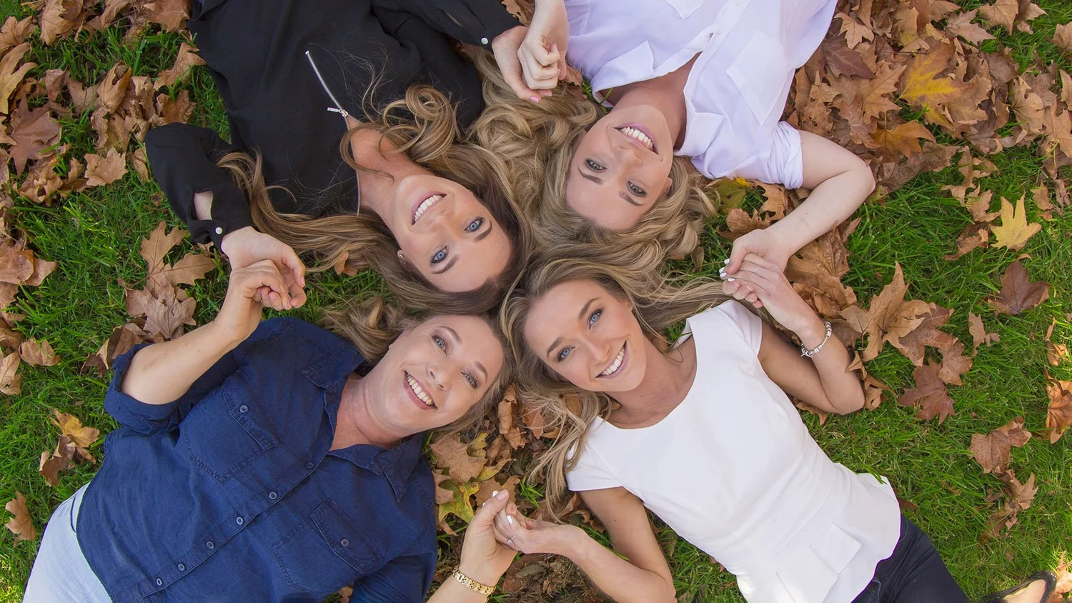 Extended family lying together outdoors