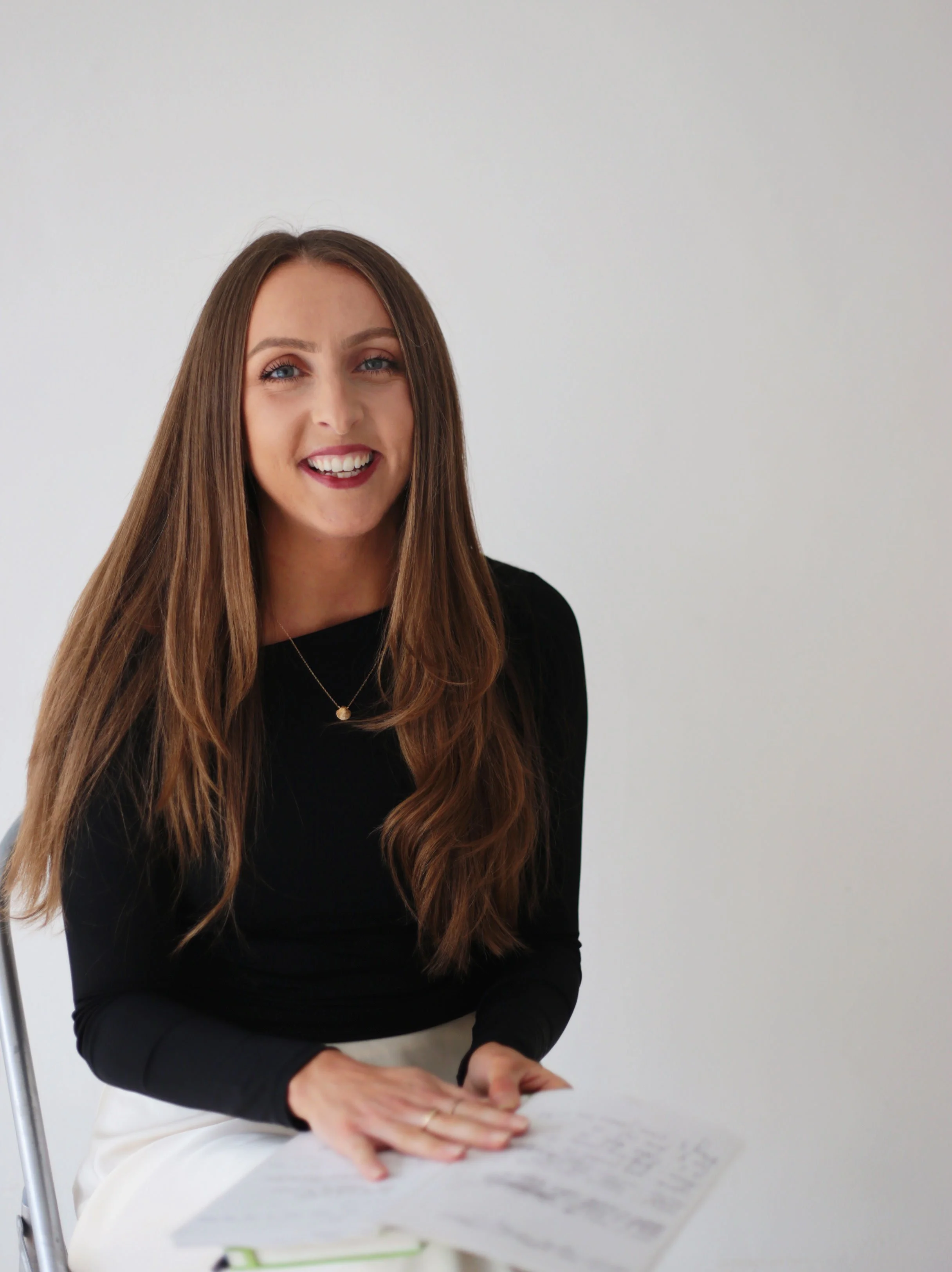Emily sitting calmly in a peaceful space reflecting warmth and grounded presence