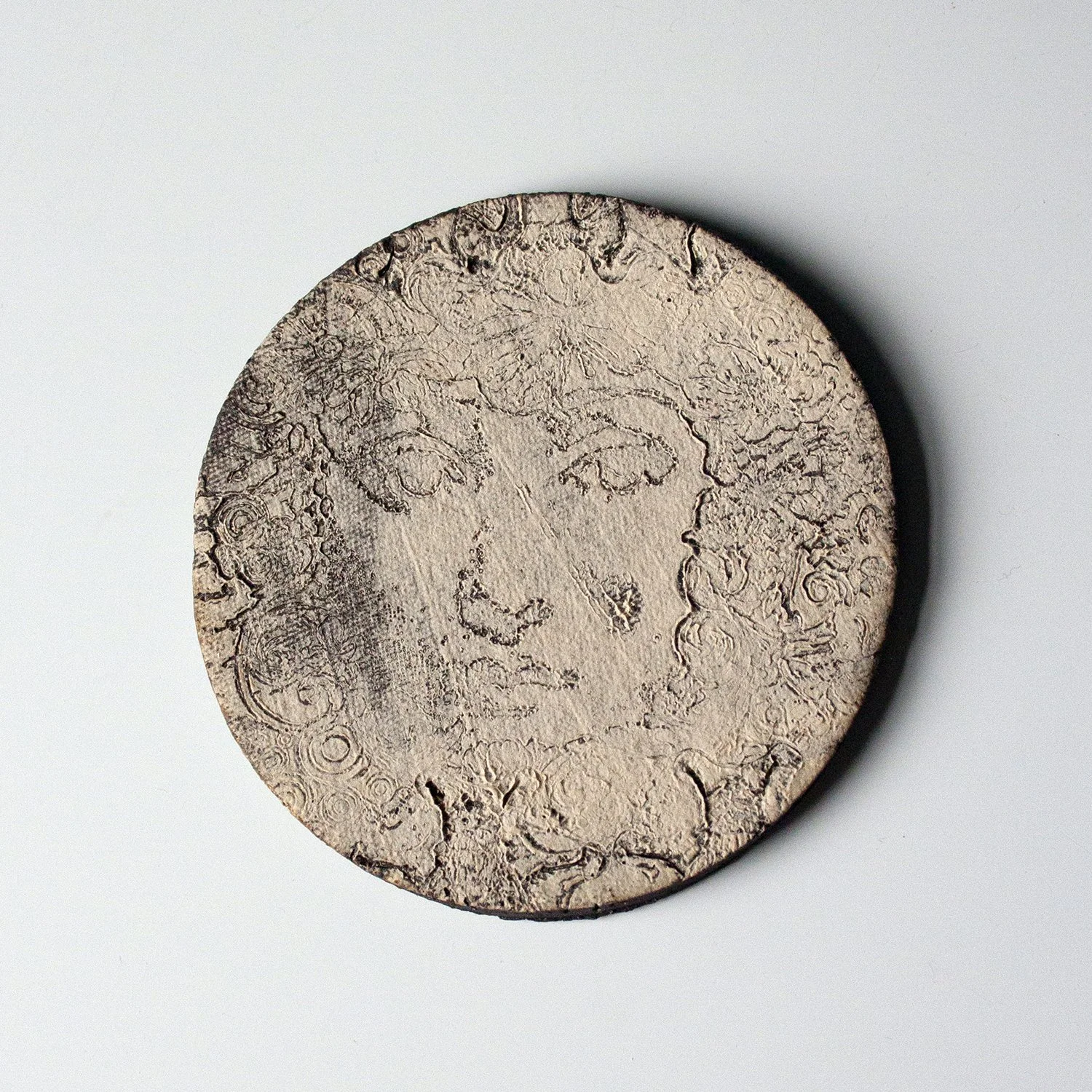 Black Clay Circle Tile with Subtle Face Detail