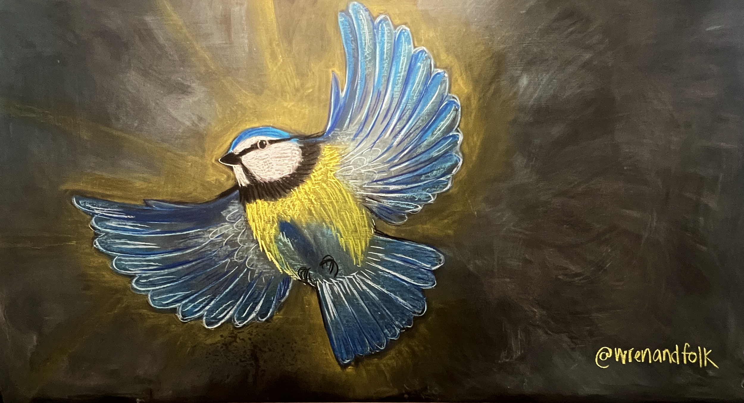 Colorful painting of a blue and yellow bird with outstretched wings against a dark background, with golden highlights and the artist's signature '@wrenandfolk' in yellow at the bottom right corner.