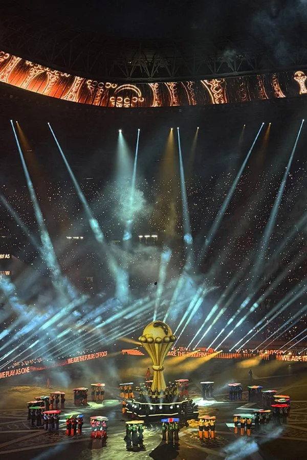 An indoor stadium with a performance stage with Official Hospitality.