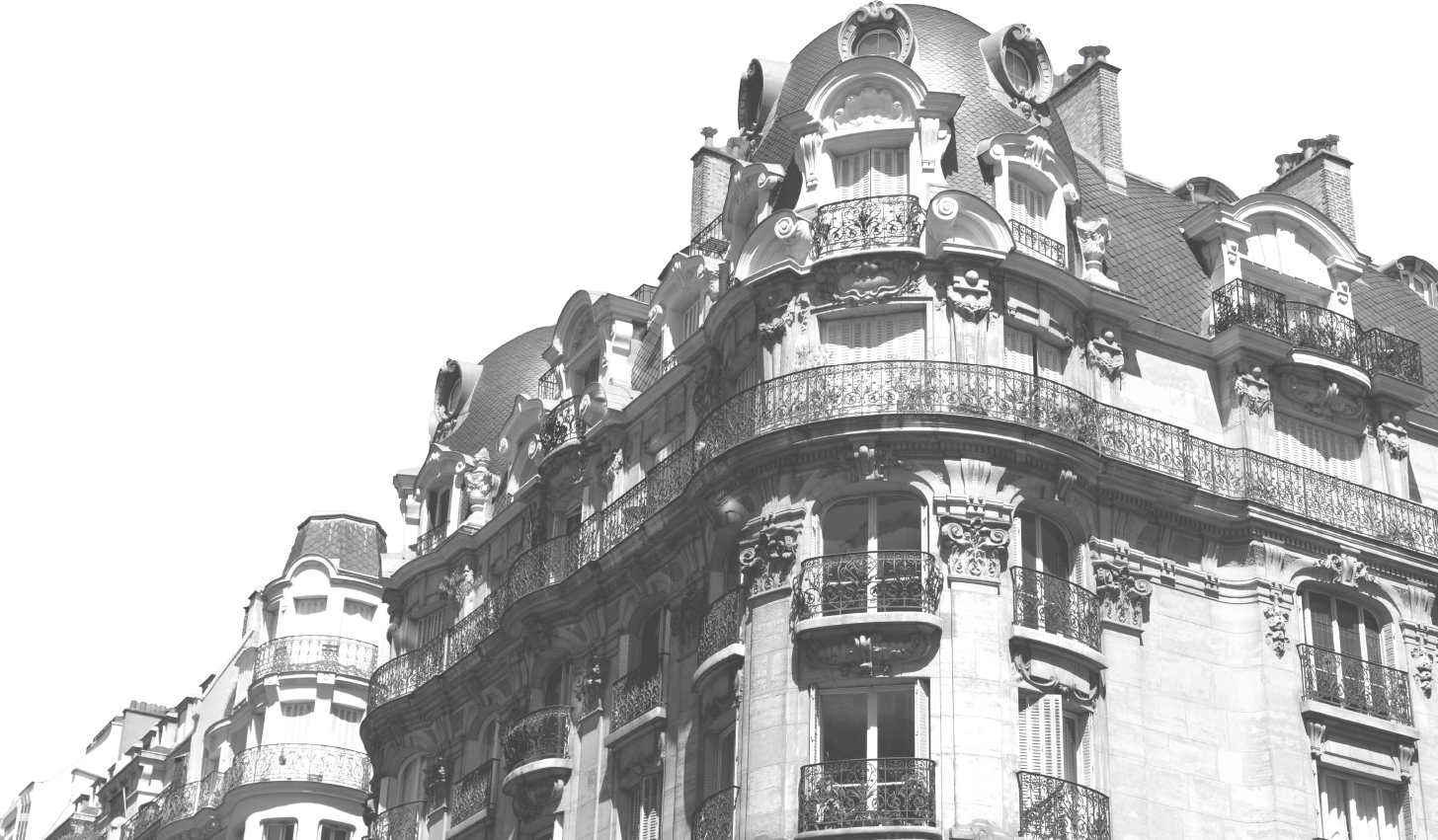 Black and white photo of a historic European-style building with ornate architectural details and balconies.