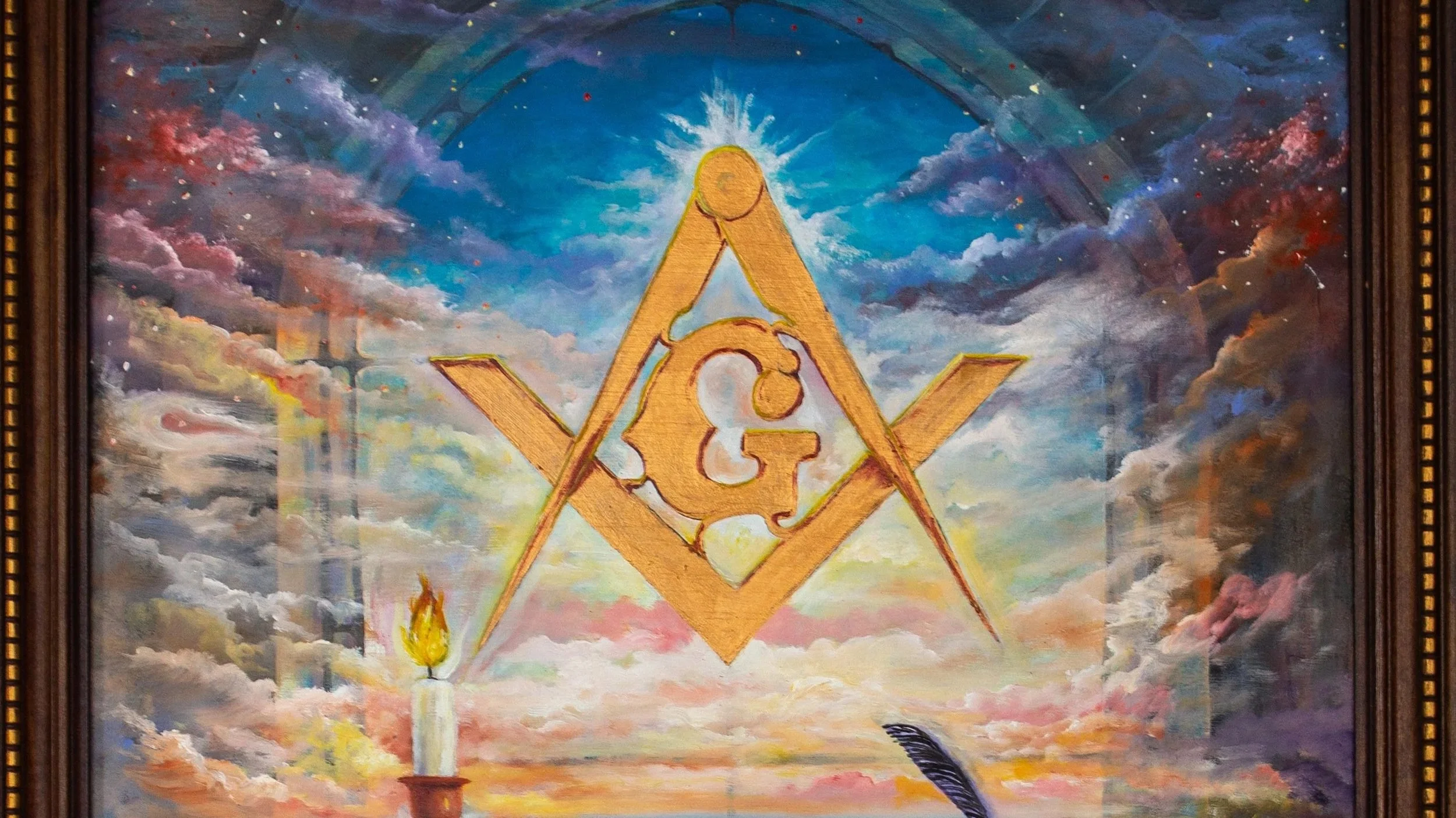 A mural depicting a large Masonic square and compass symbol with a radiant sun at the top and an eternal flame at the bottom, set against a colorful sky background with clouds.