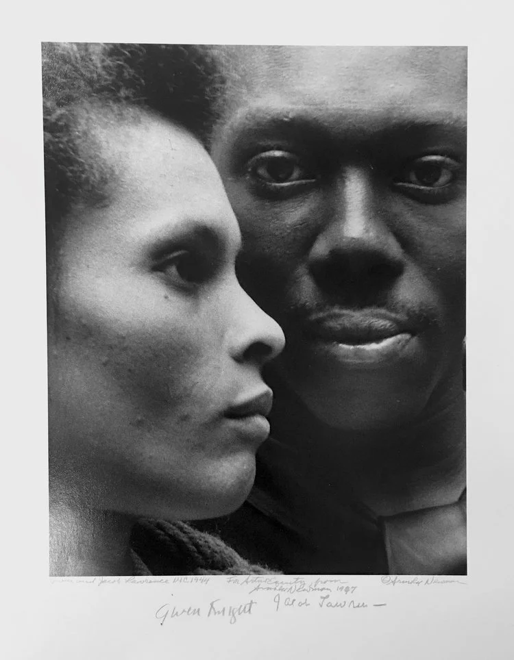 Black and white portrait of two people close together, a woman on the left profile and a man on the right facing forward.