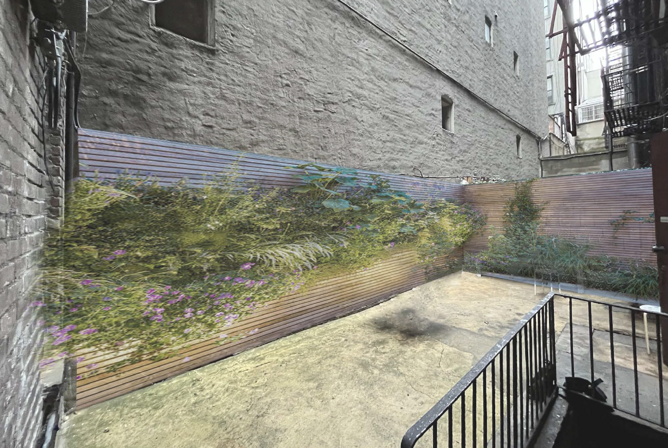 Small outdoor urban space with a mural of plants and flowers on the back wall, surrounded by brick and concrete buildings, with a black metal railing in the foreground.