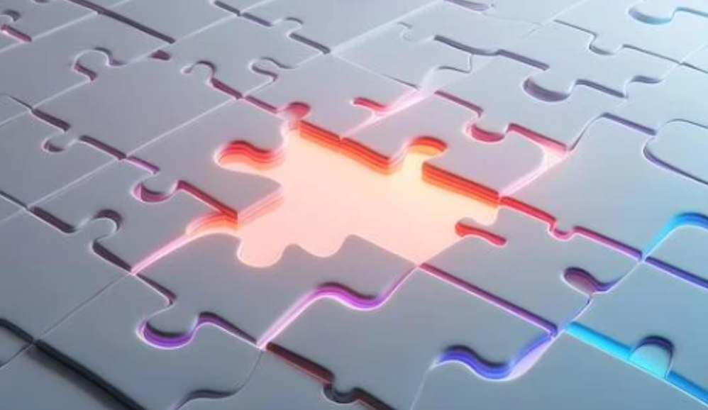 A close-up of white puzzle pieces with a glowing outline, with some pieces illuminated in rainbow colors, forming a larger shape.