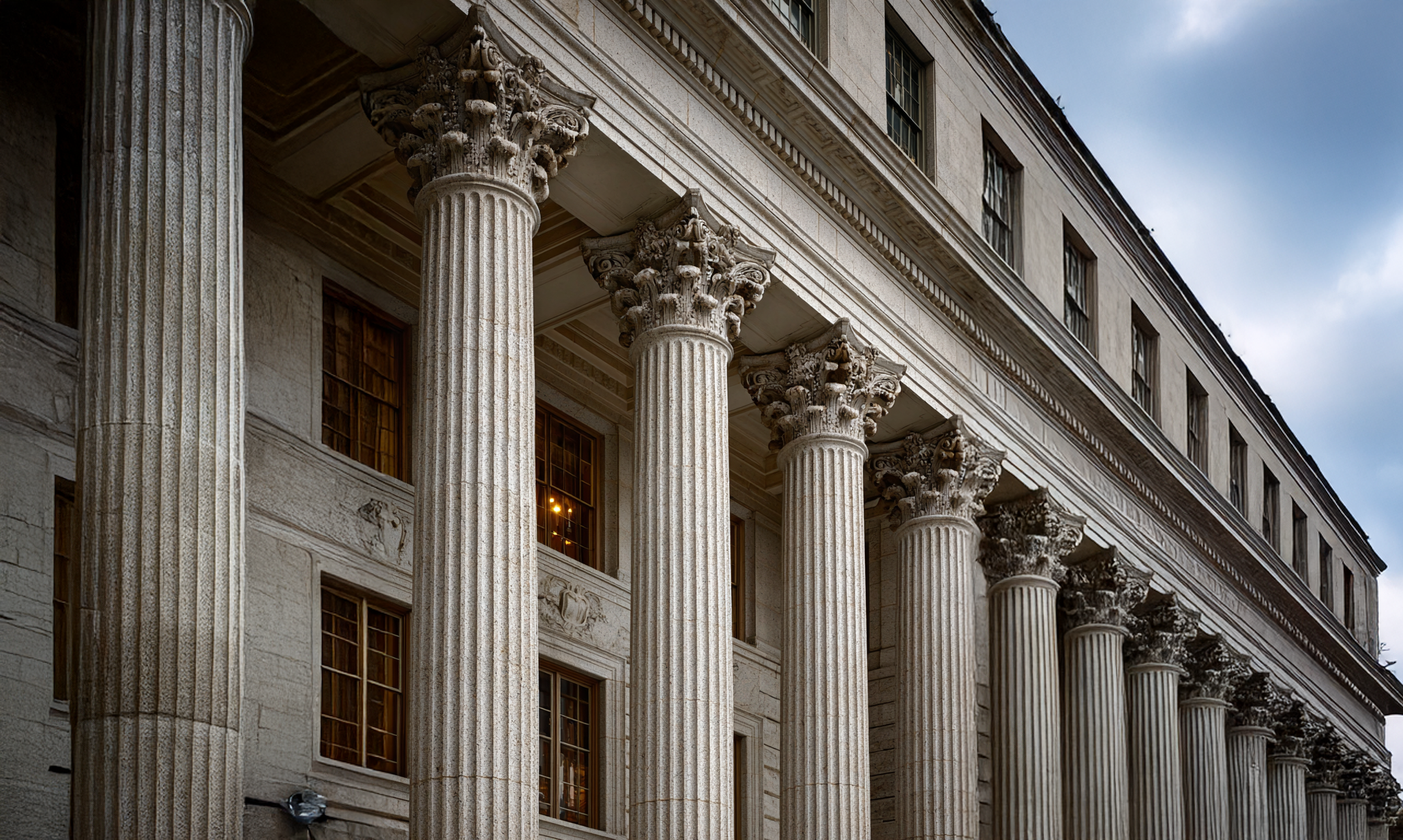 Exterior of a historic building with tall Corinthian columns and classical architecture.
