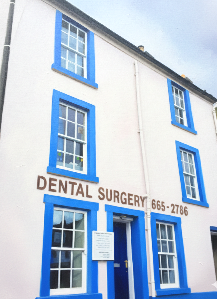 White building with blue window frames and a door, with a sign that reads "DENTAL SURGERY" and a phone number, 665-2786.