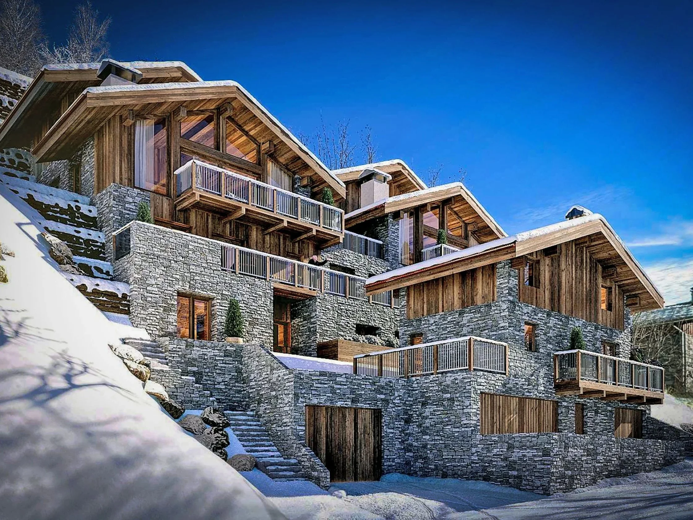 Exemple de chalets de luxe réalisés près de Saint-Martin-de-Belleville, architecture en bois et pierre, terrasses et façades enneigées au cœur des 3 Vallées.