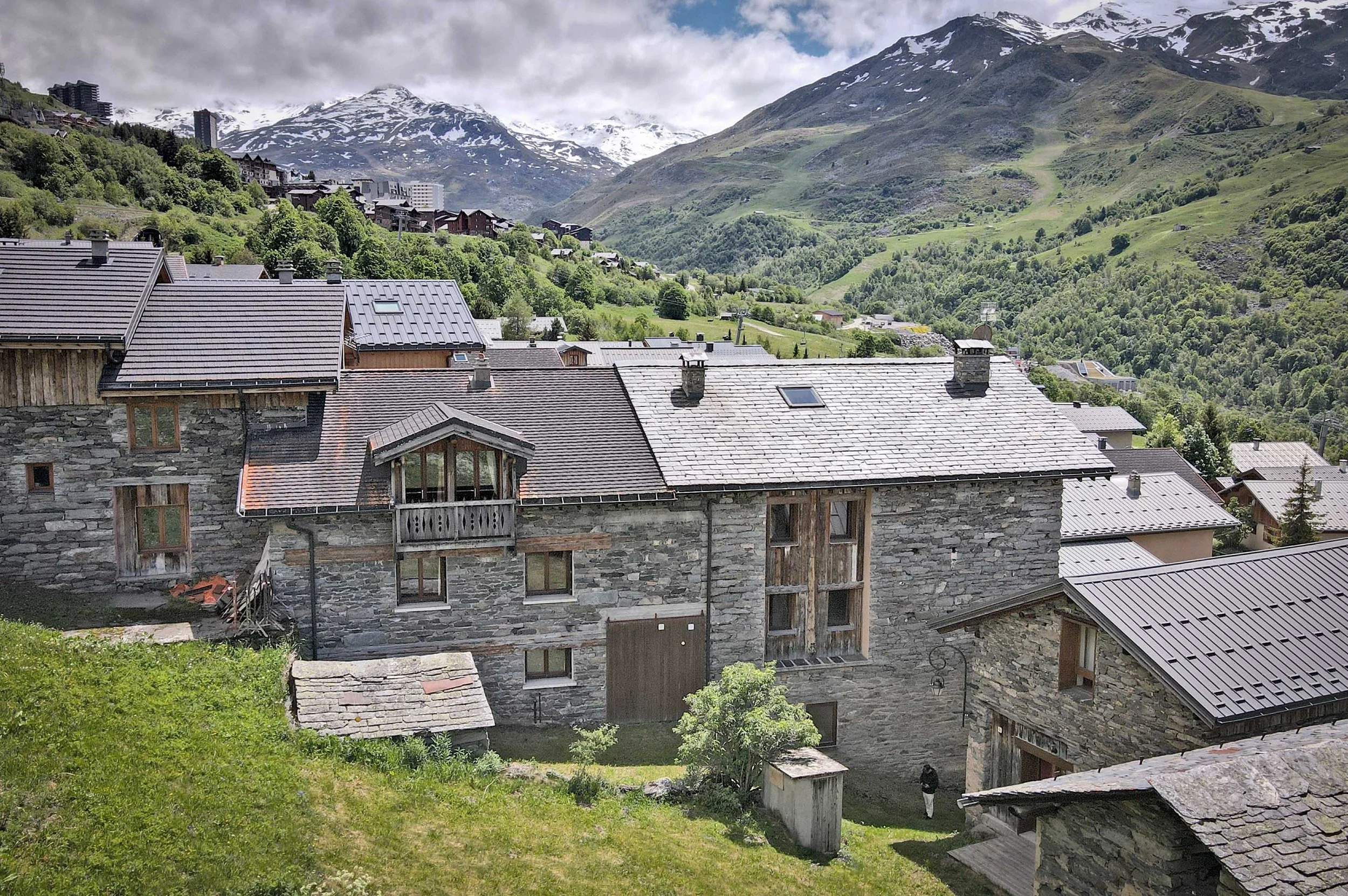 Maison de caractère en pierre proposée à la vente par HOME SUMMIT, bénéficiant d’un emplacement privilégié à proximité des pistes de ski des Menuires et d’une vue remarquable sur les montagnes environnantes.