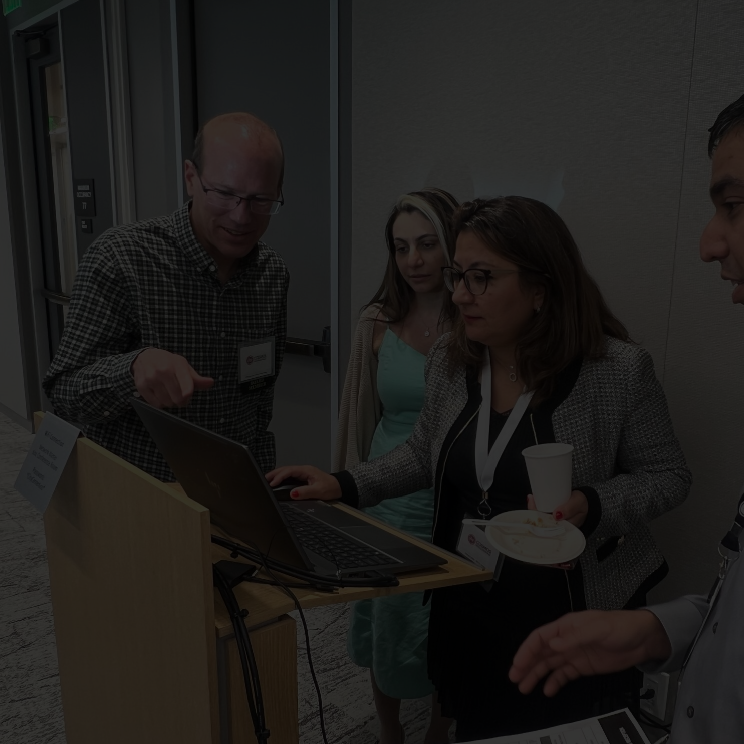 Group of people working over a document to find strong-motion observation systems.