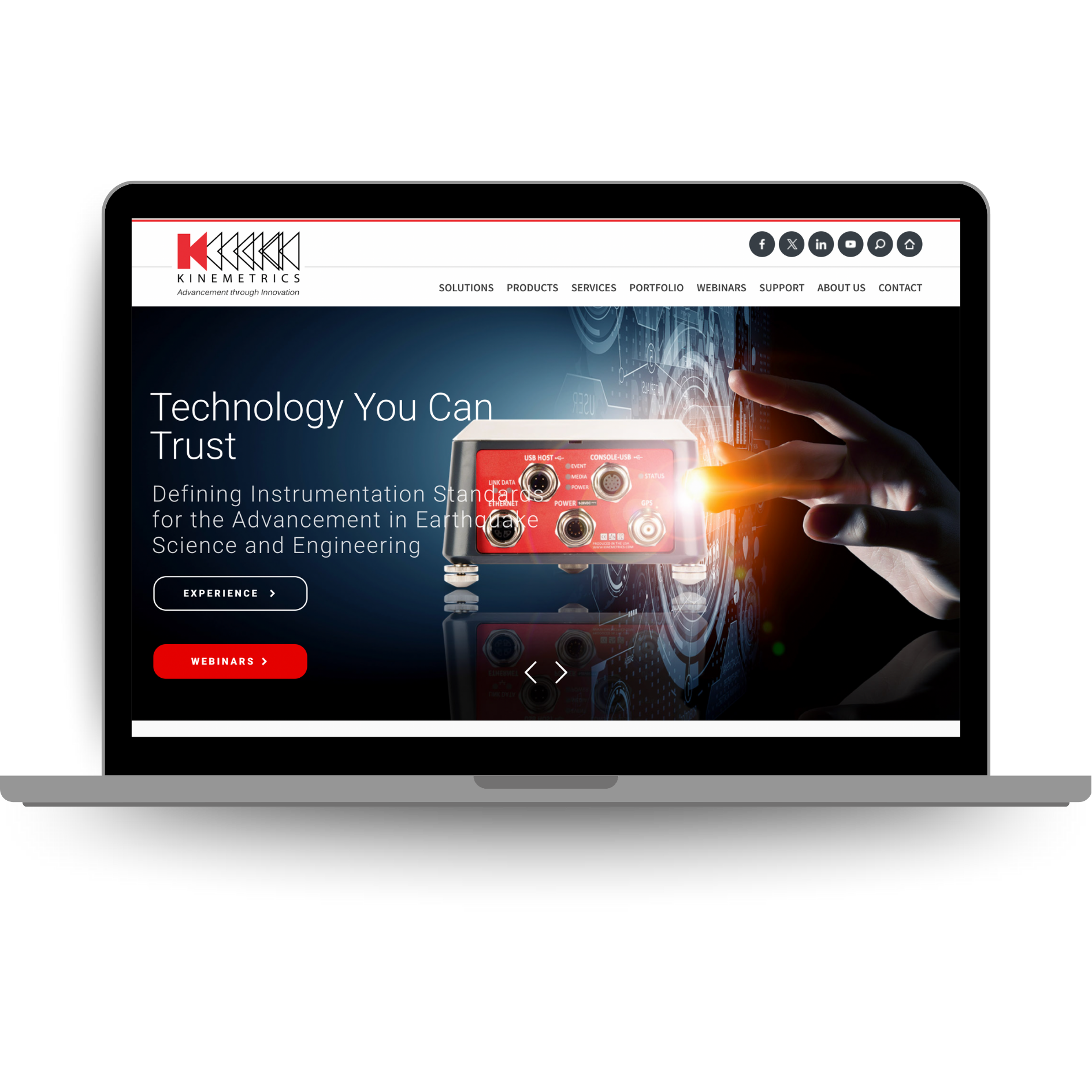 Laptop displaying the Kinemetrics website featuring advanced instrumentation solutions for earthquake science and structural engineering.