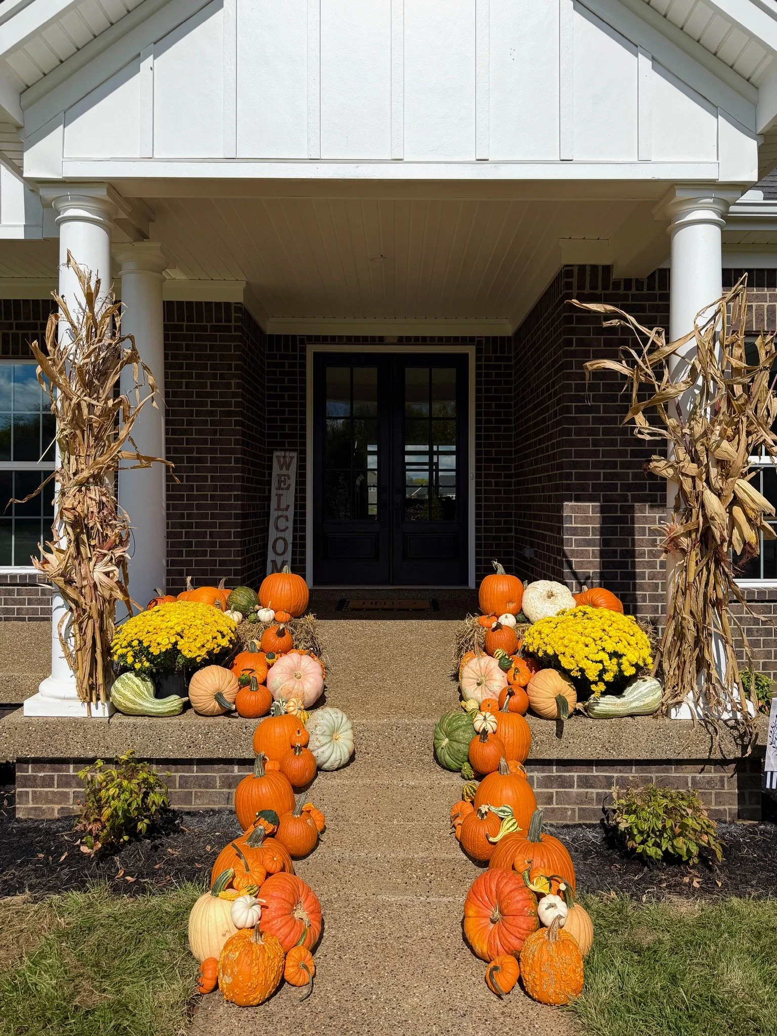 Custom pumpkin porch decorating in Louisville, KY designed to create a warm and inviting fall entrance.