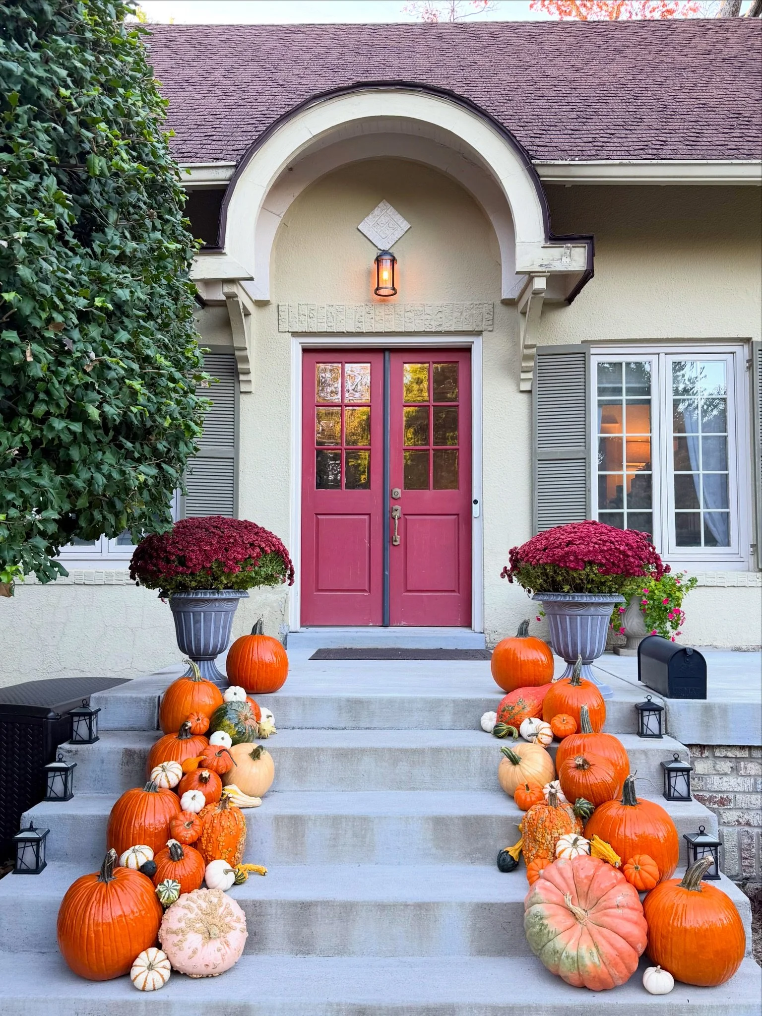 Luxury fall porch decorating in Louisville, KY with specialty pumpkins, layered textures, and autumn colors.