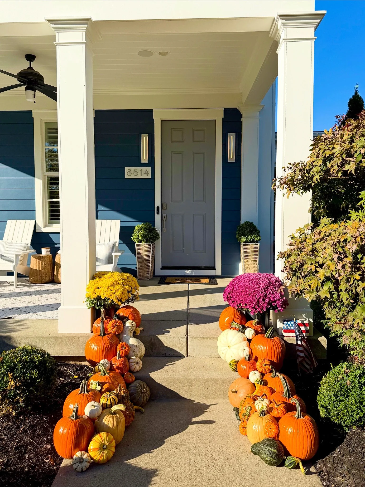 Beautiful autumn porch design in Norton Commons, KY showcasing custom pumpkin arrangements and fall décor.