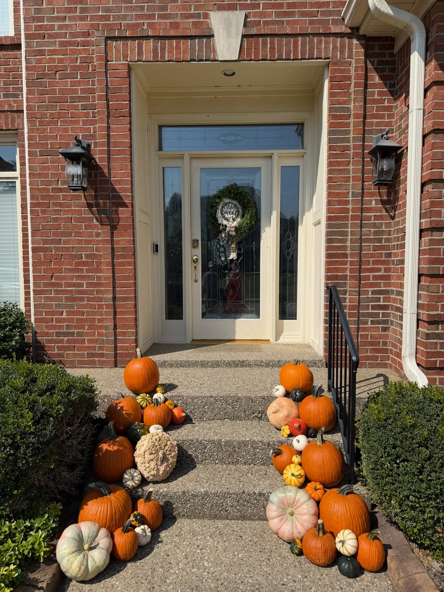 Louisville KY fall porch décor with hand-selected pumpkins, mums, and professionally styled autumn decorations.