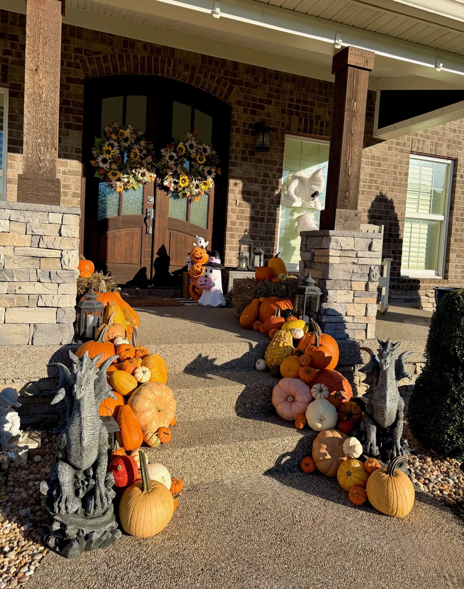 Custom fall porch decorating in Prospect, KY with stacked pumpkins, cornstalks, and luxury autumn styling.