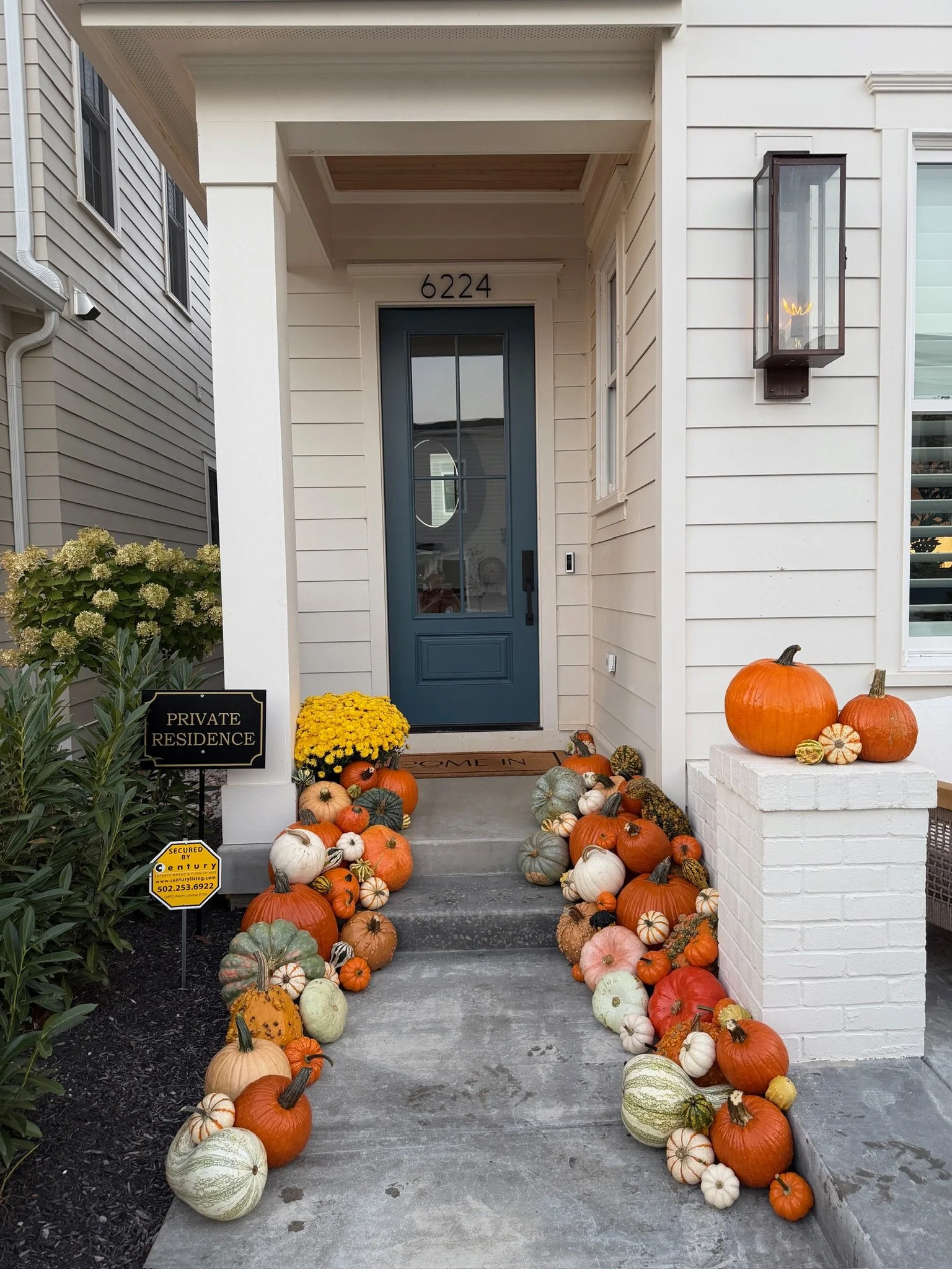 Front porch pumpkin display in Norton Commons KY featuring premium fall decorations and seasonal styling.
