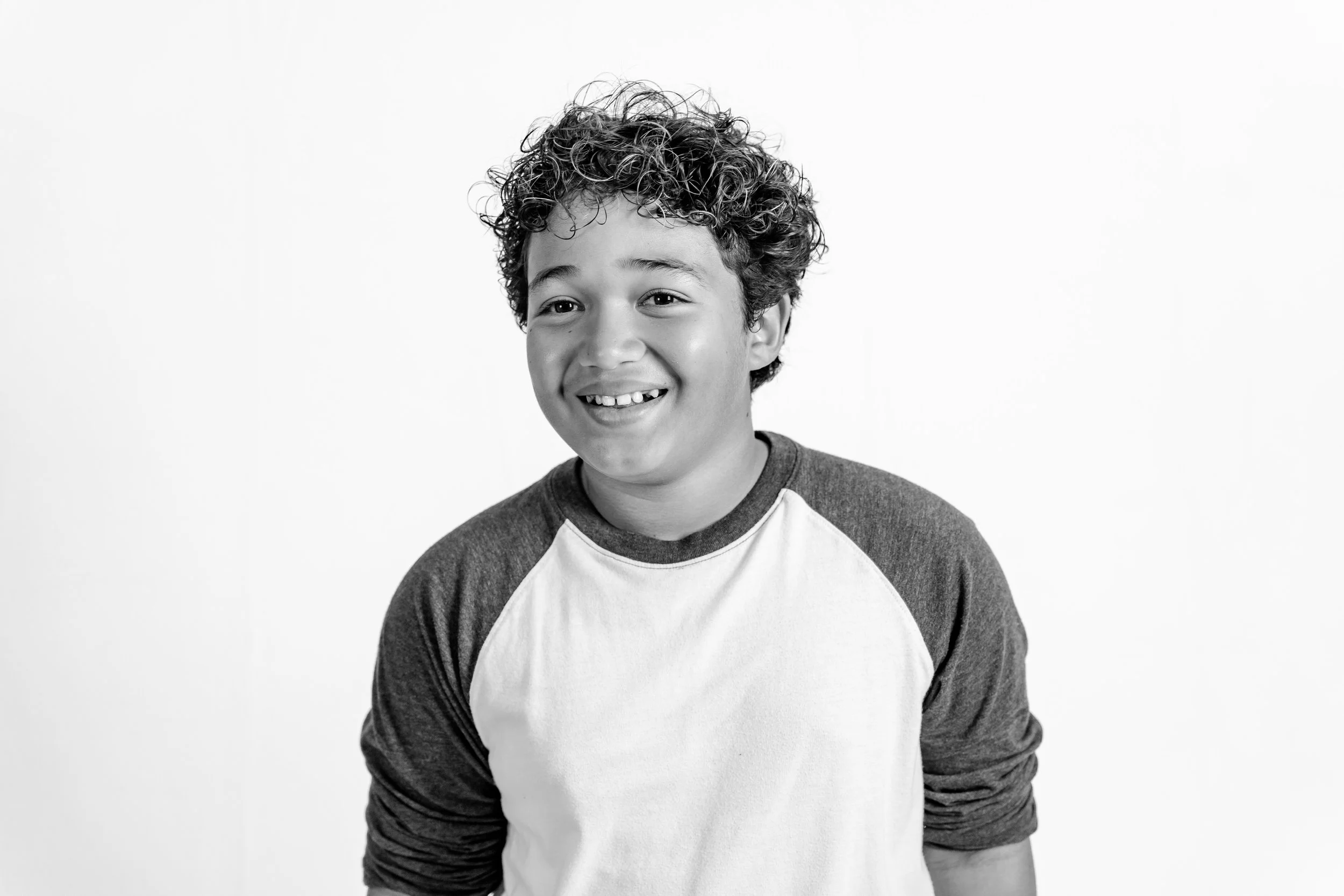 Black and white personality portrait of smiling boy during Oklahoma City mini session.