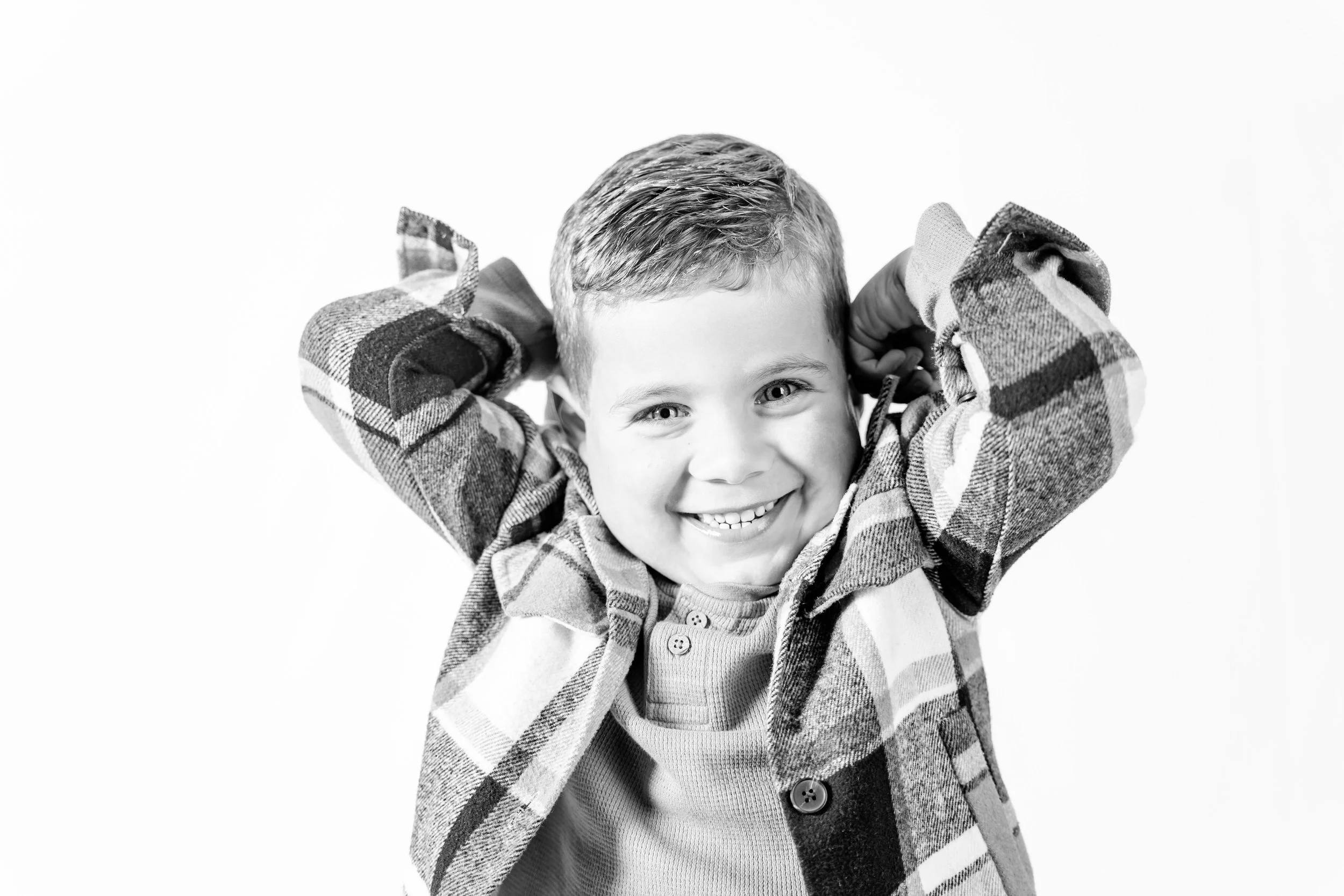 Black and white portrait of smiling boy during Oklahoma City Personality Portrait session.