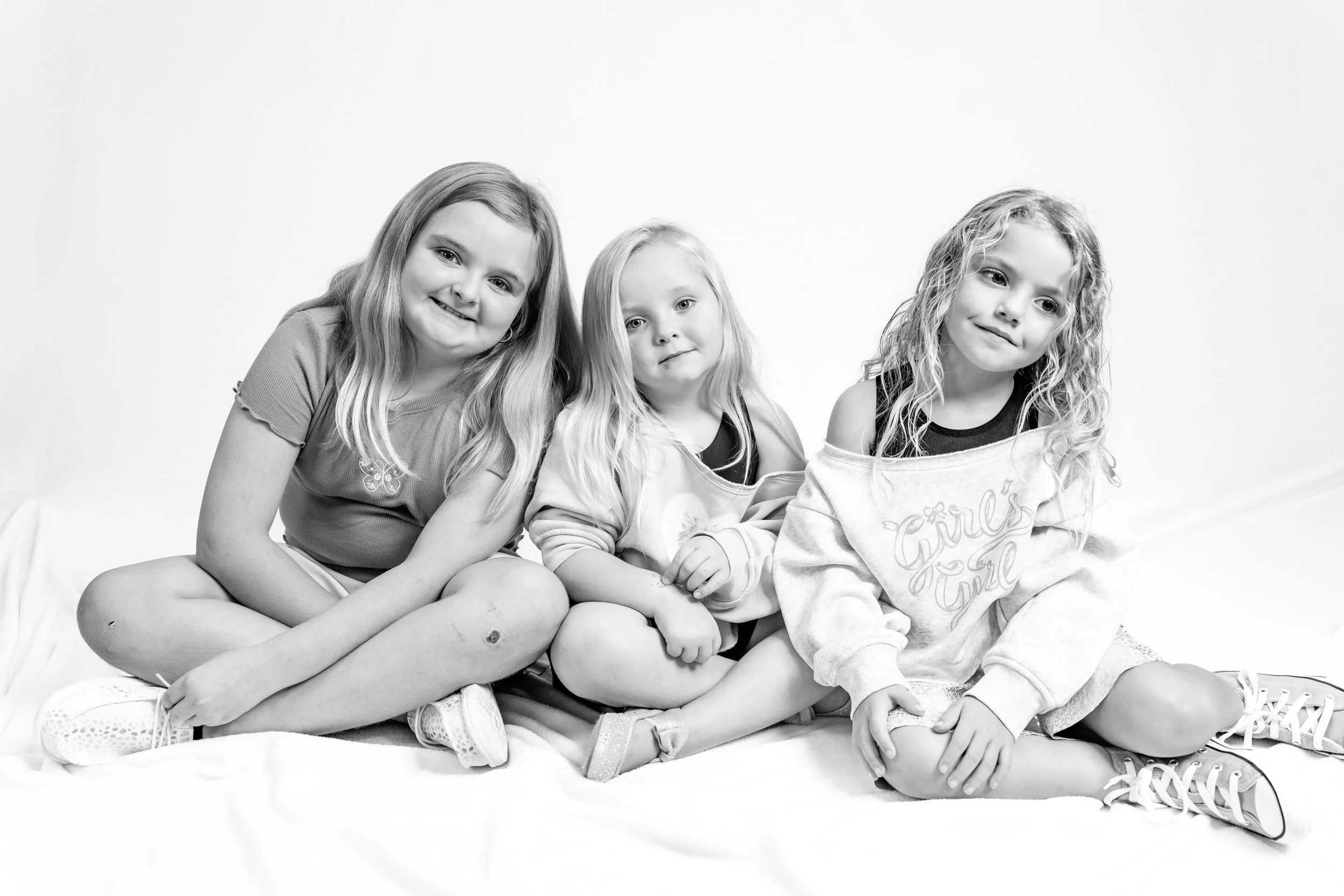 Black and white personality portrait of three sisters sitting together during Oklahoma City mini session.