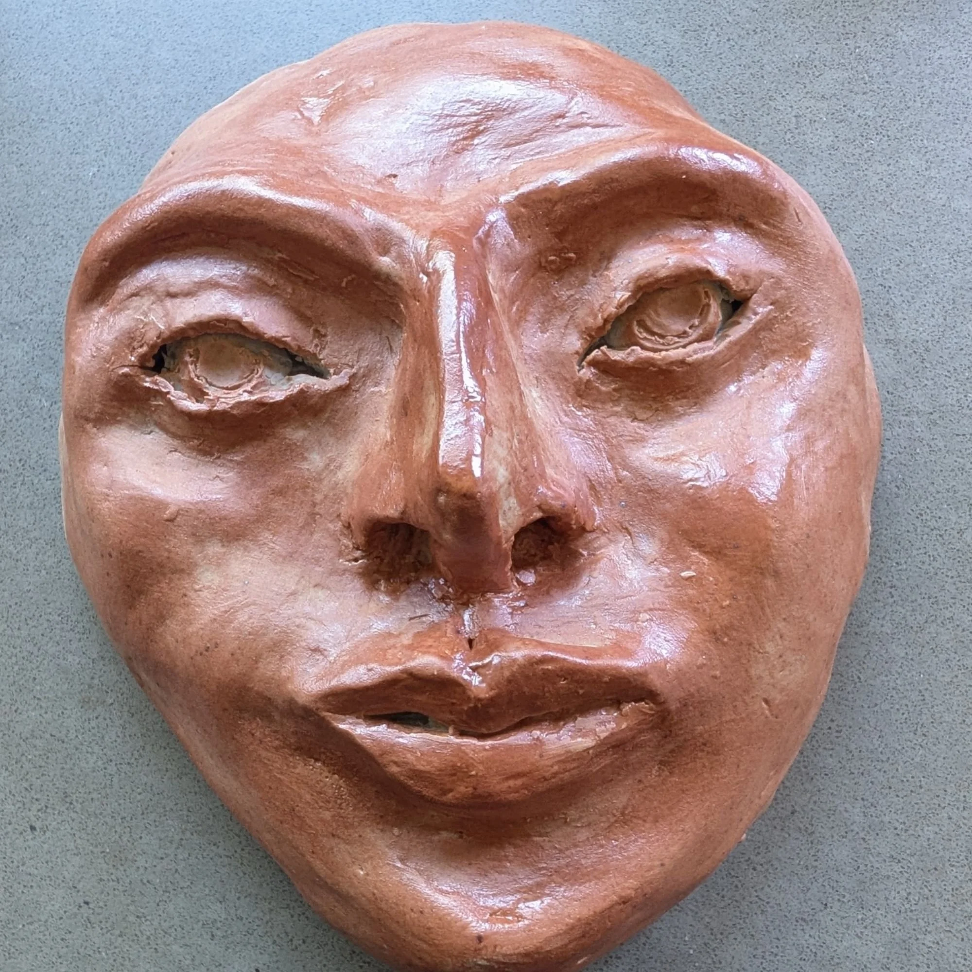 Sun's ceramic face after firing, before the mosaic