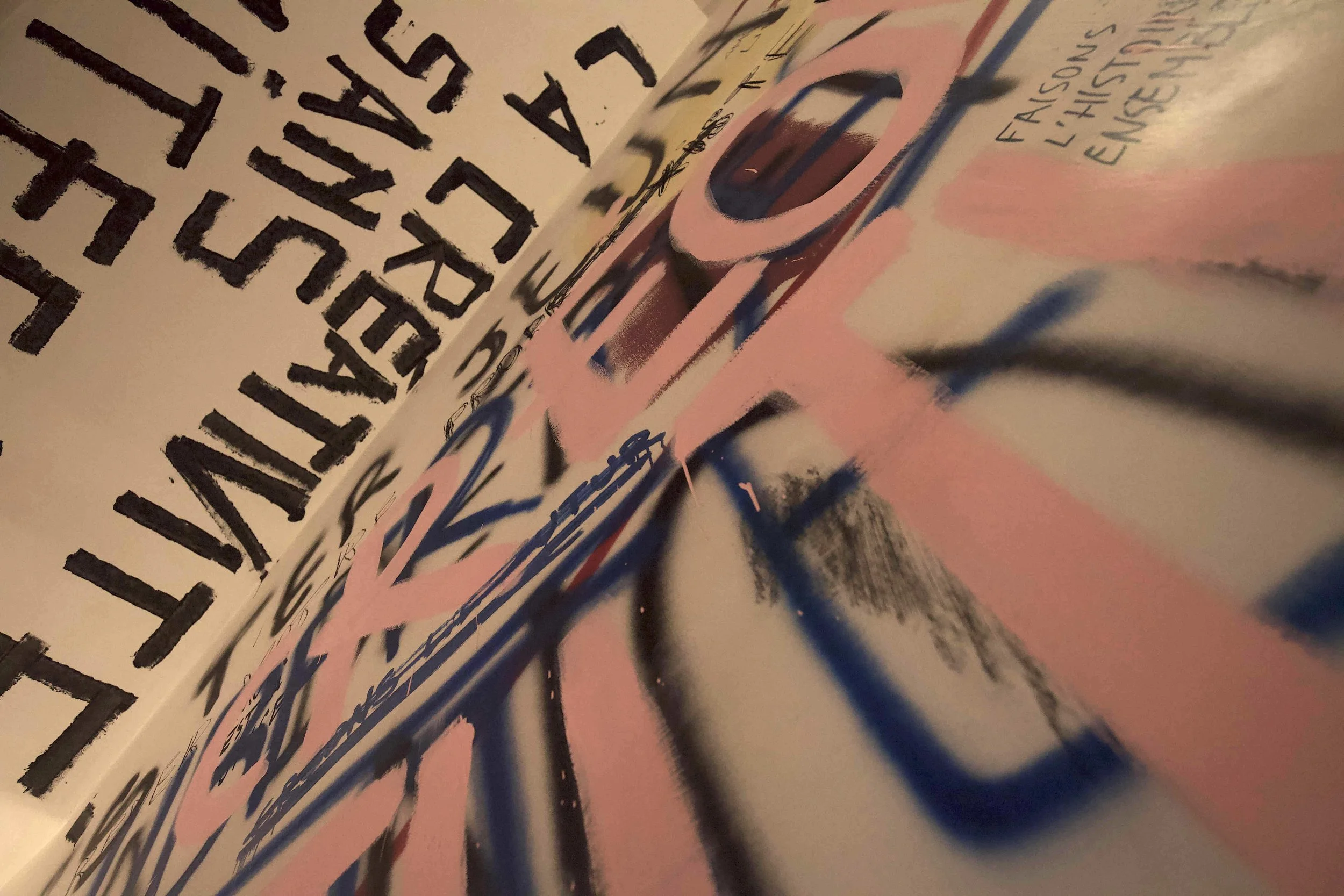 Un'illustrazione astratta con colori rosa, blu e nero, con testo scritto e disegni vari.
