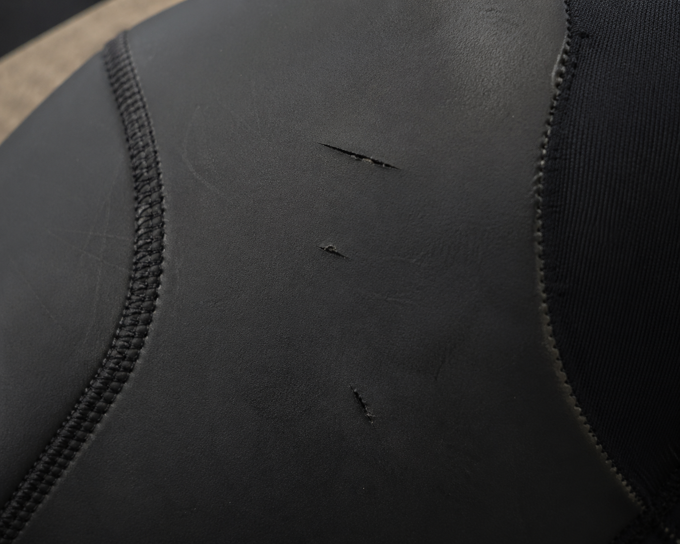 Close-up of a neoprene wetsuit with some scratches in it.