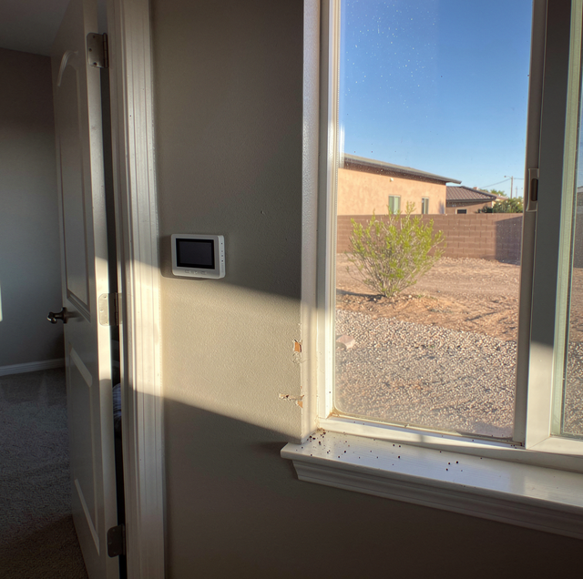 infrared thermometer showing temperature variance between house rooms