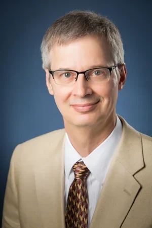 Professional headshot of Carl Migliazzo