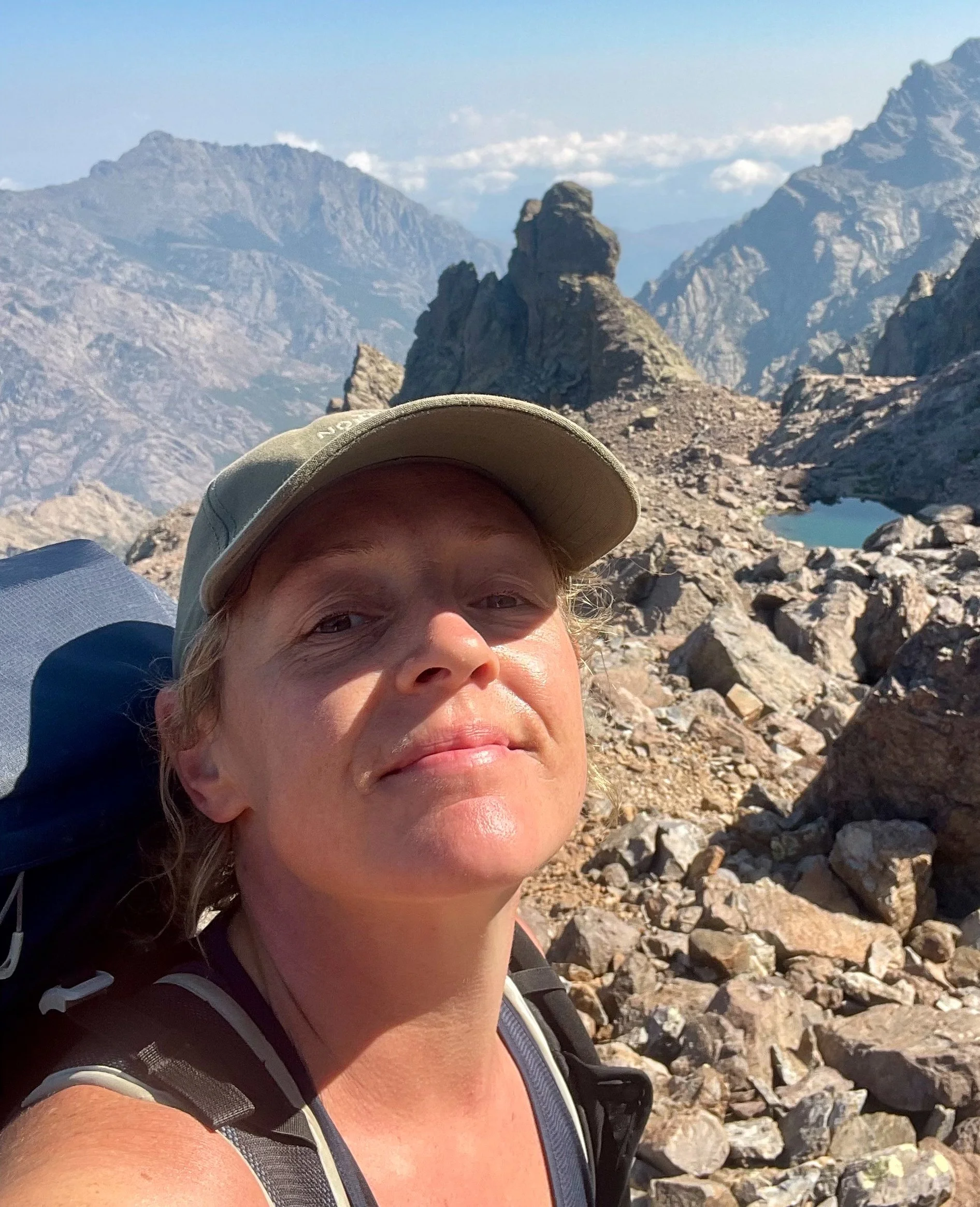Mountain artist Cat Goward hiking in the mountains on GR20
