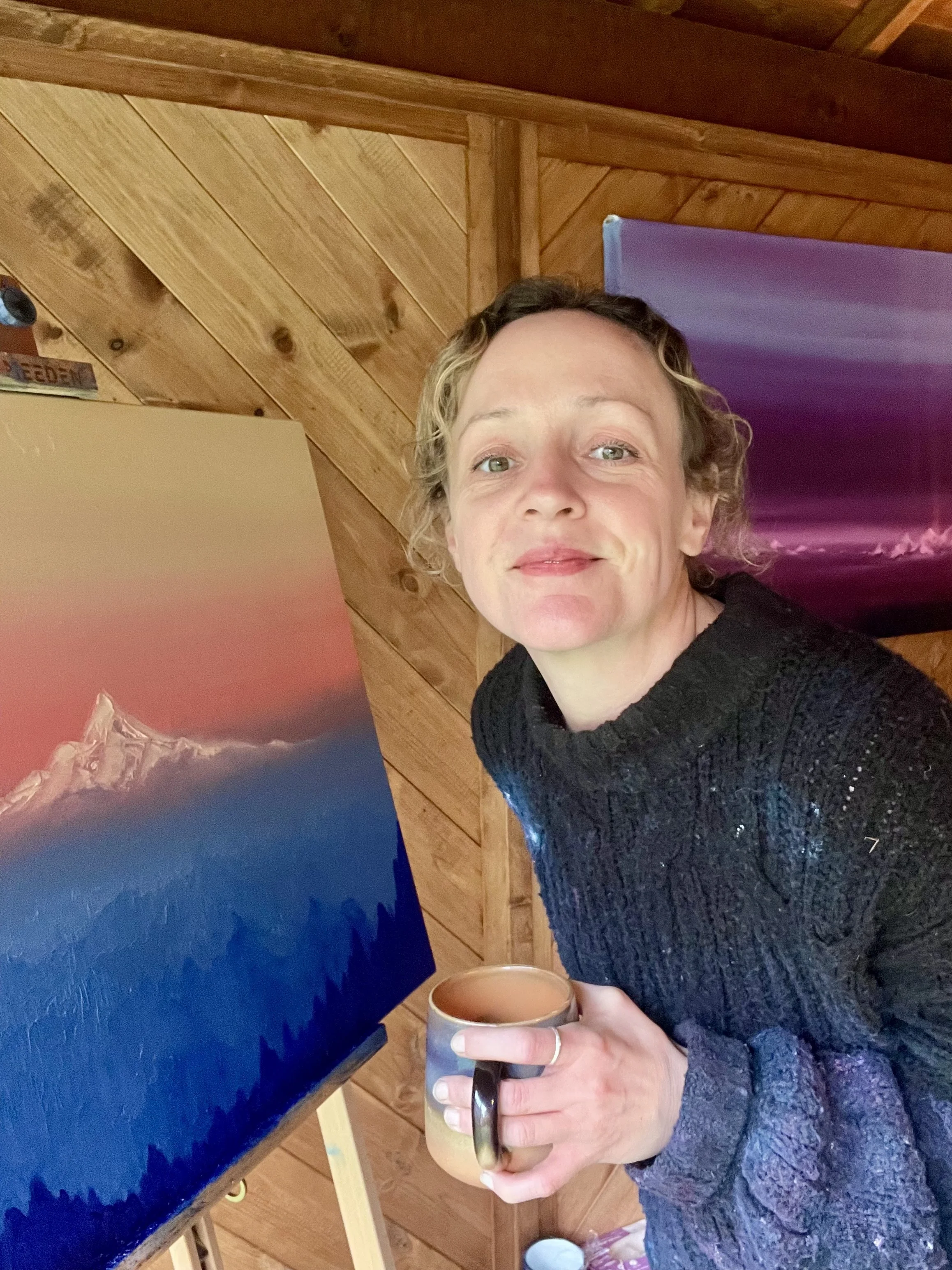 Mountain artist Cat Goward painting in her studio