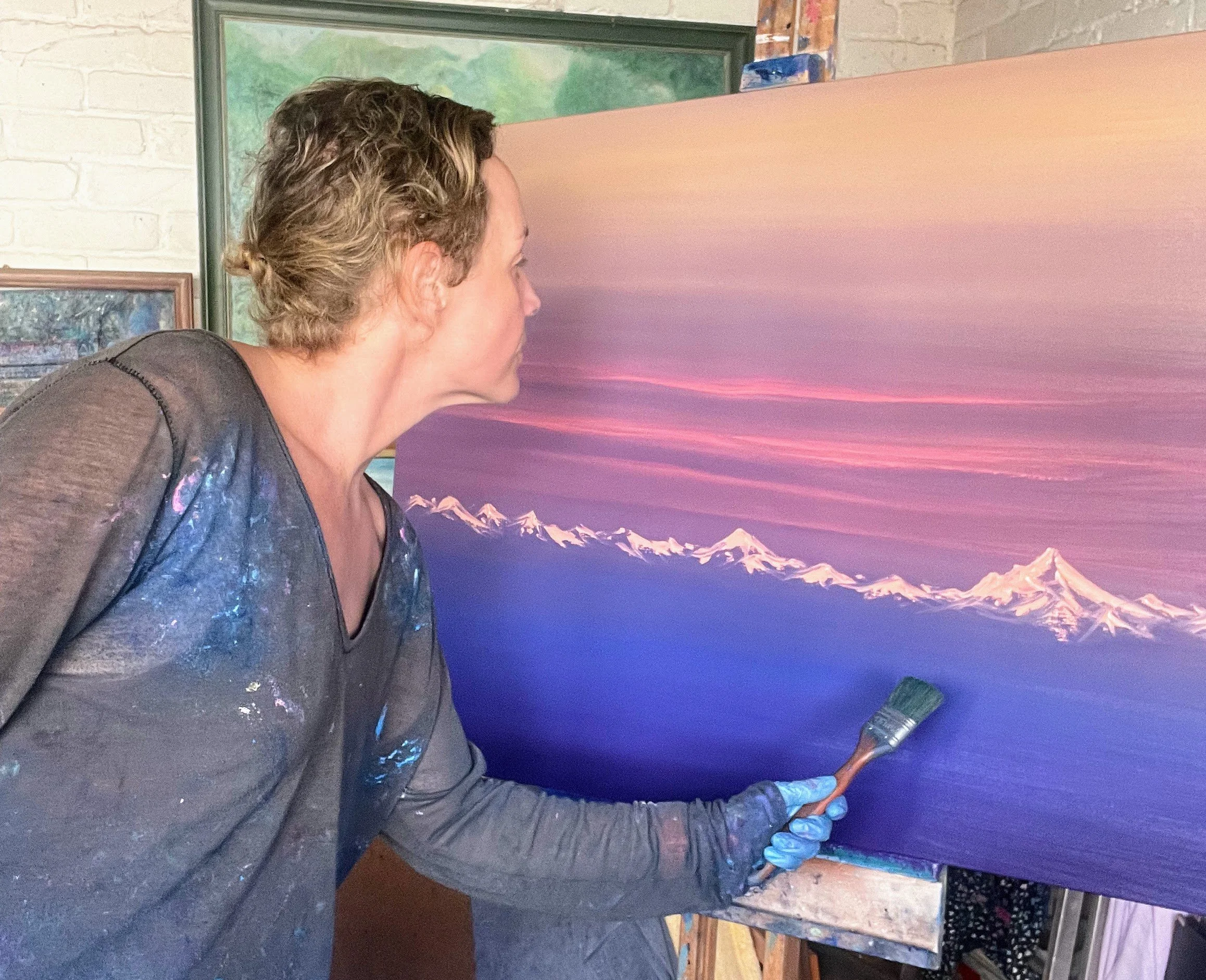 Cat Goward painting mountains in her Kent studio