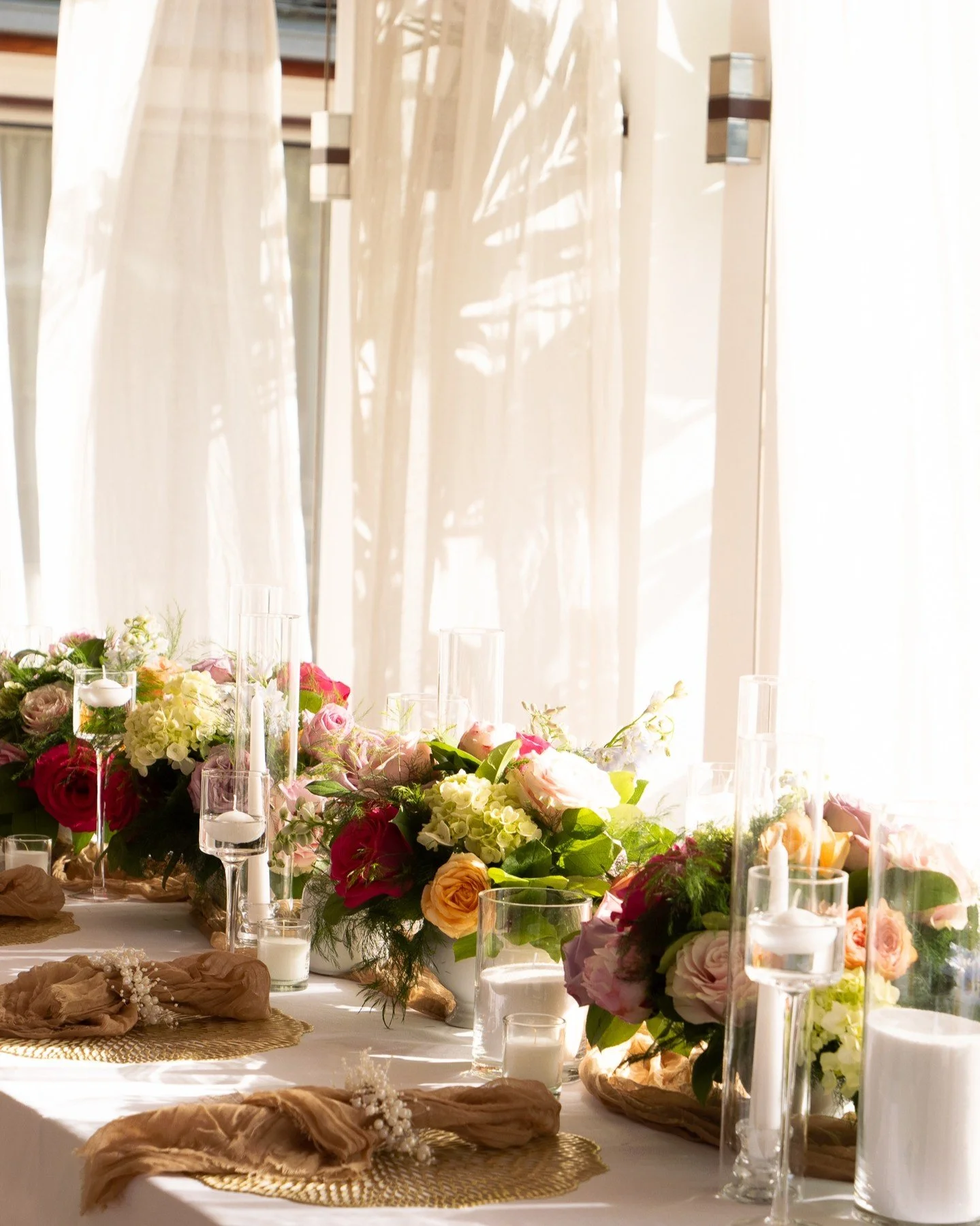 Soft draping, floating candles, layered textures, and floral centrepieces in rich romantic tones.
A tablescape designed for connection &mdash; intimate, warm, and glowing as the sun set over Villa Blanc Bleu.
Details that elevate the moment without o