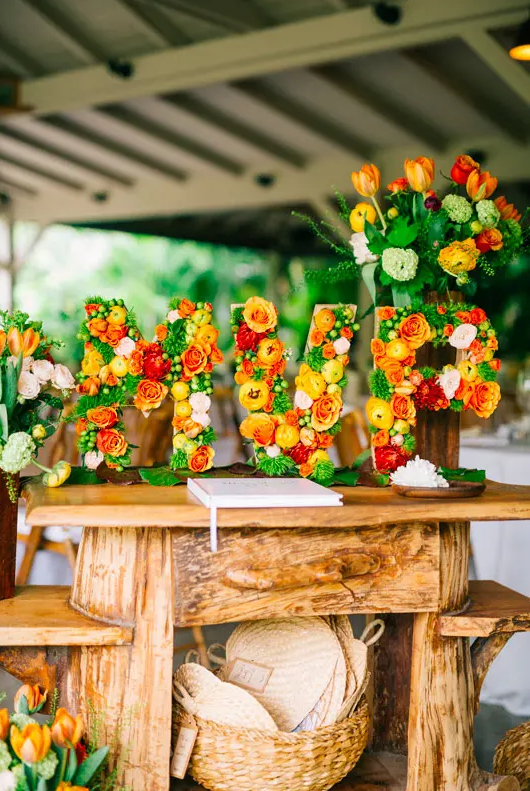 Vibrant wedding table decorated with tropical fruits and colorful flowers for a festive celebration in St Barth.