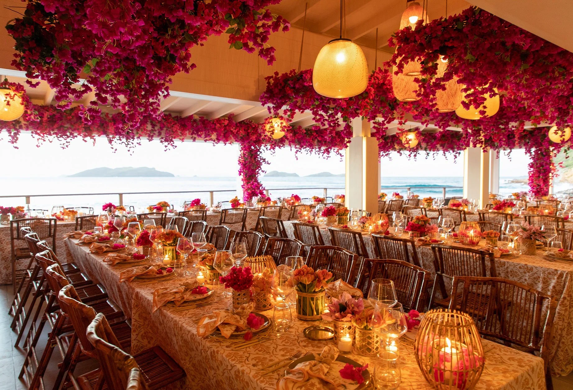 Glamorous wedding reception filled with fuchsia and pink floral arrangements for a vibrant celebration in St Barth.