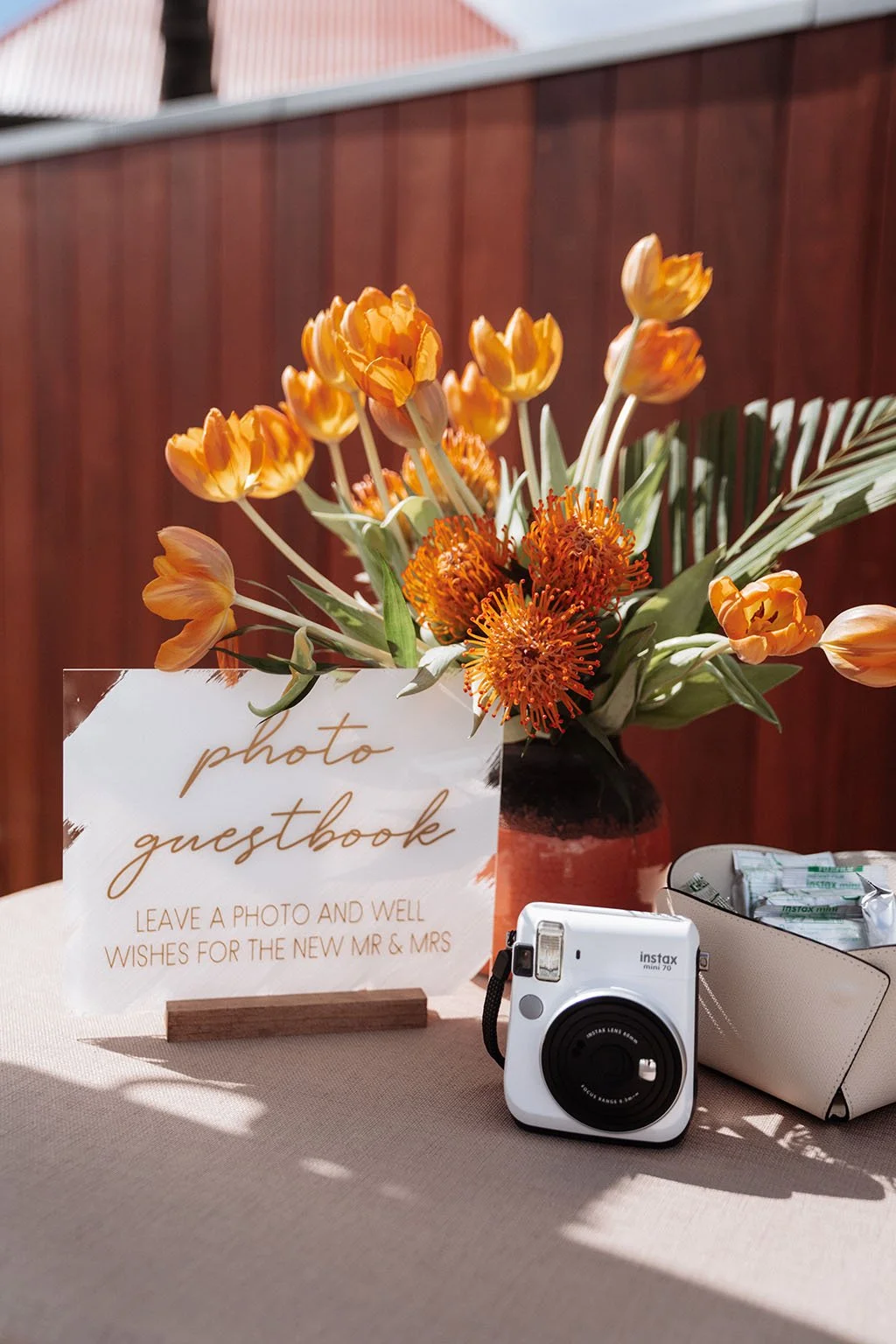 Wedding table detail with orange flowers, personalized menu, and elegant design in St Barth.