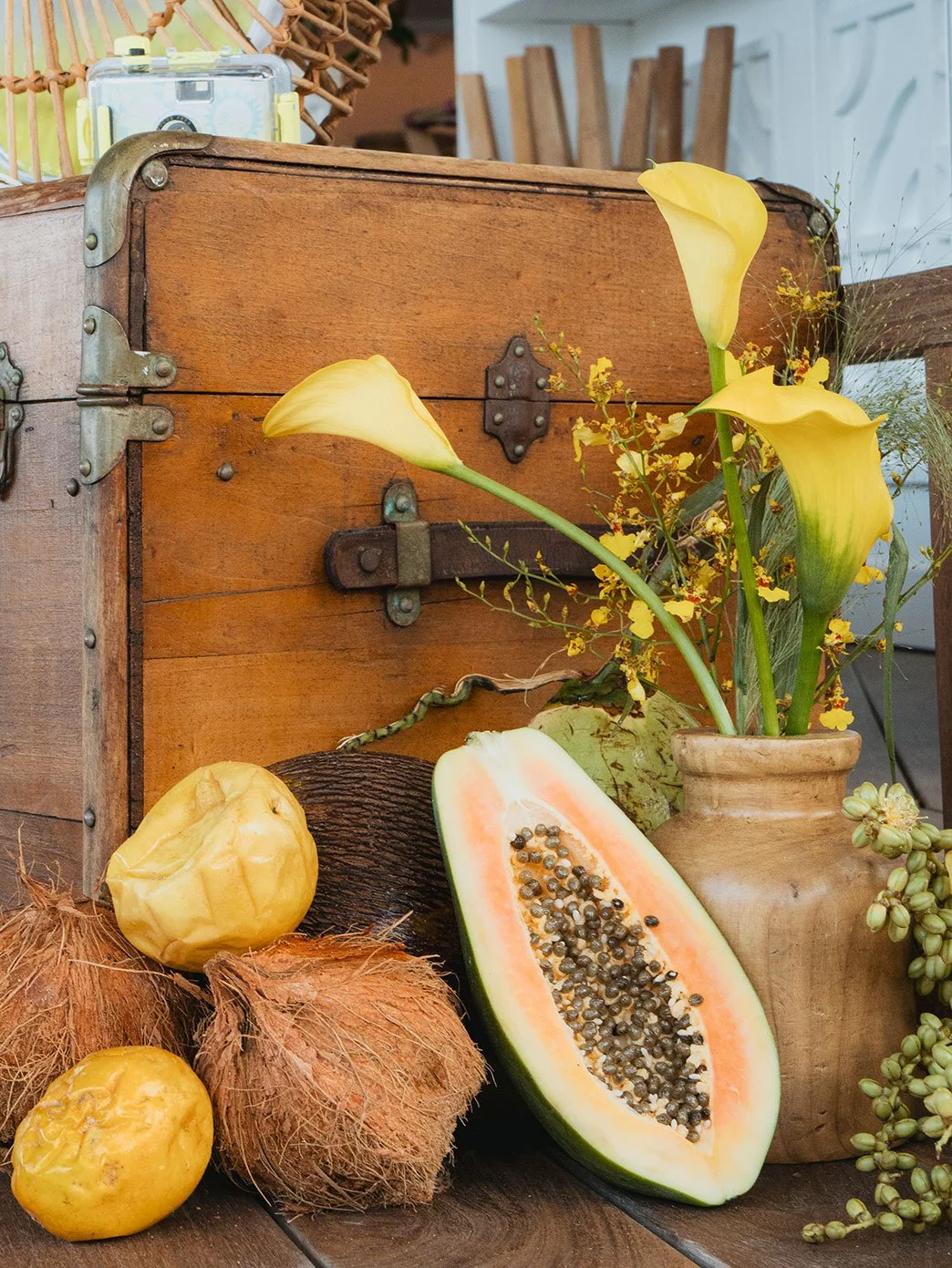 Tropical fruit and flower arrangement featuring papayas and yellow blooms for a colorful wedding in St Barth.