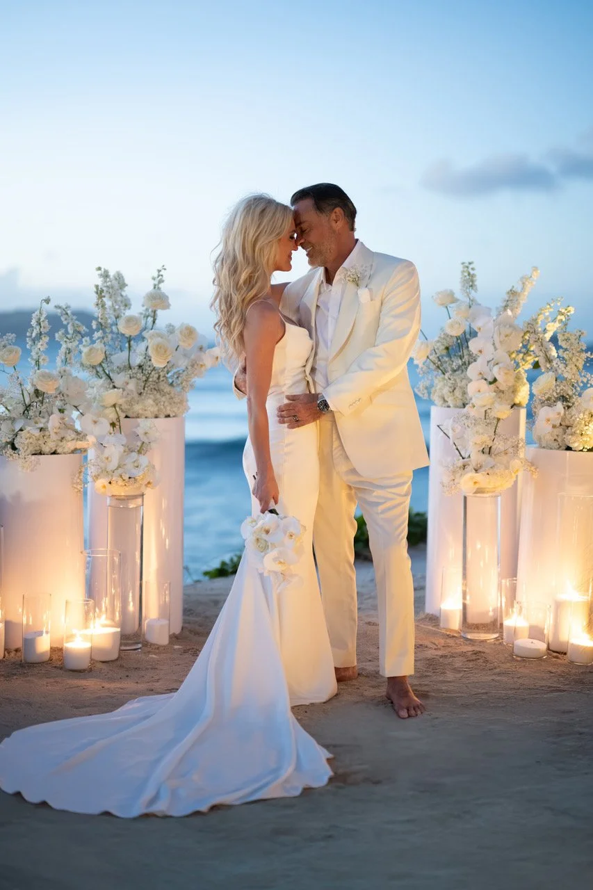 Romantic wedding moment under a white floral arch with candlelight, celebrating love in St Barth.