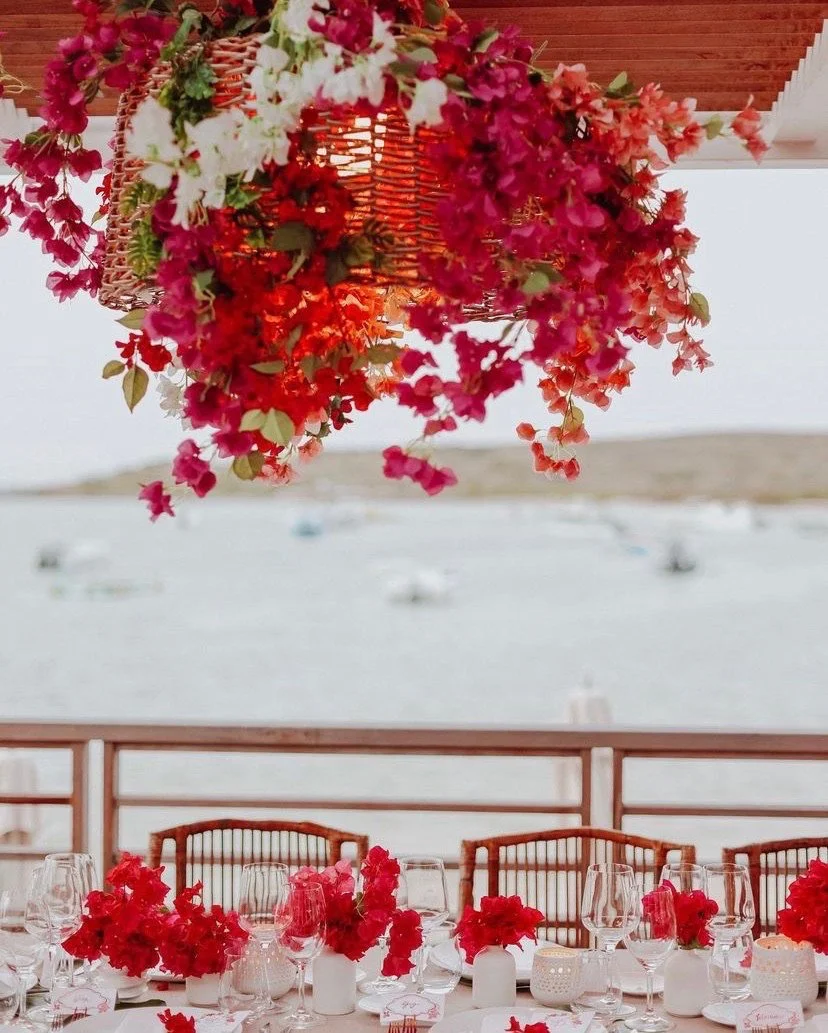 Vibrant floral ceiling installation in shades of red and pink for a tropical wedding reception in St Barth.