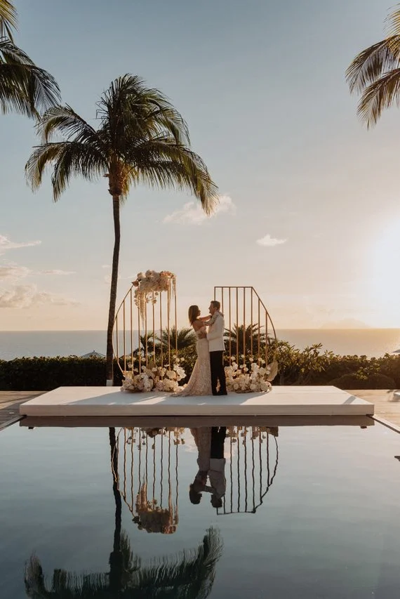 Romantic wedding moment by the water at sunset, surrounded by tropical elegance in St Barth.