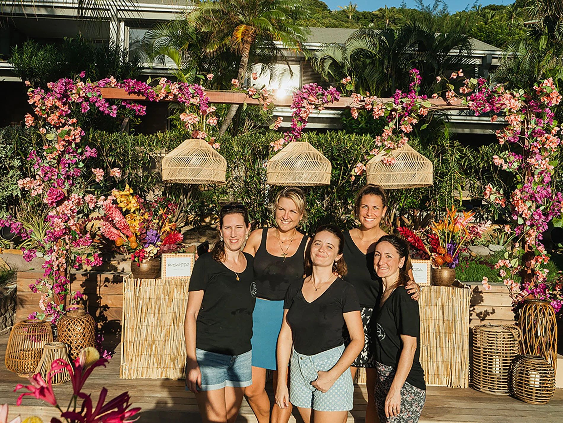 Florist team posing together after setting up a vibrant tropical floral installation for a wedding event in St Barth.